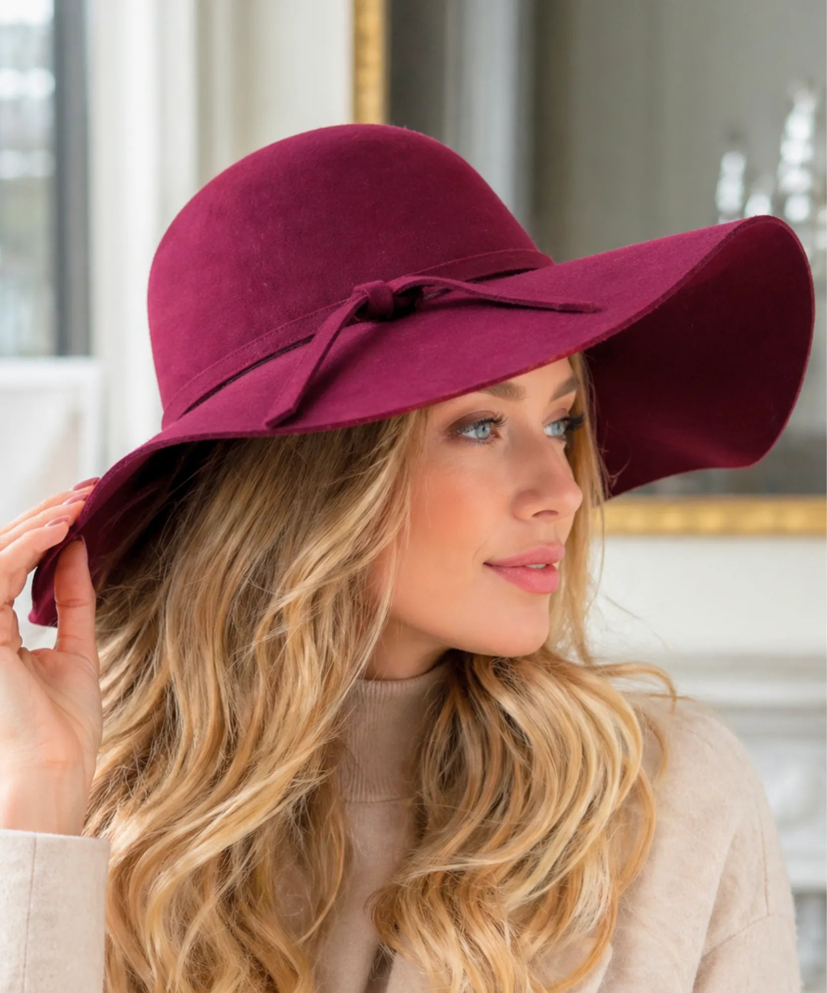 Woman wearing a Burgundy wide-brim wool felt fedora hat, side view