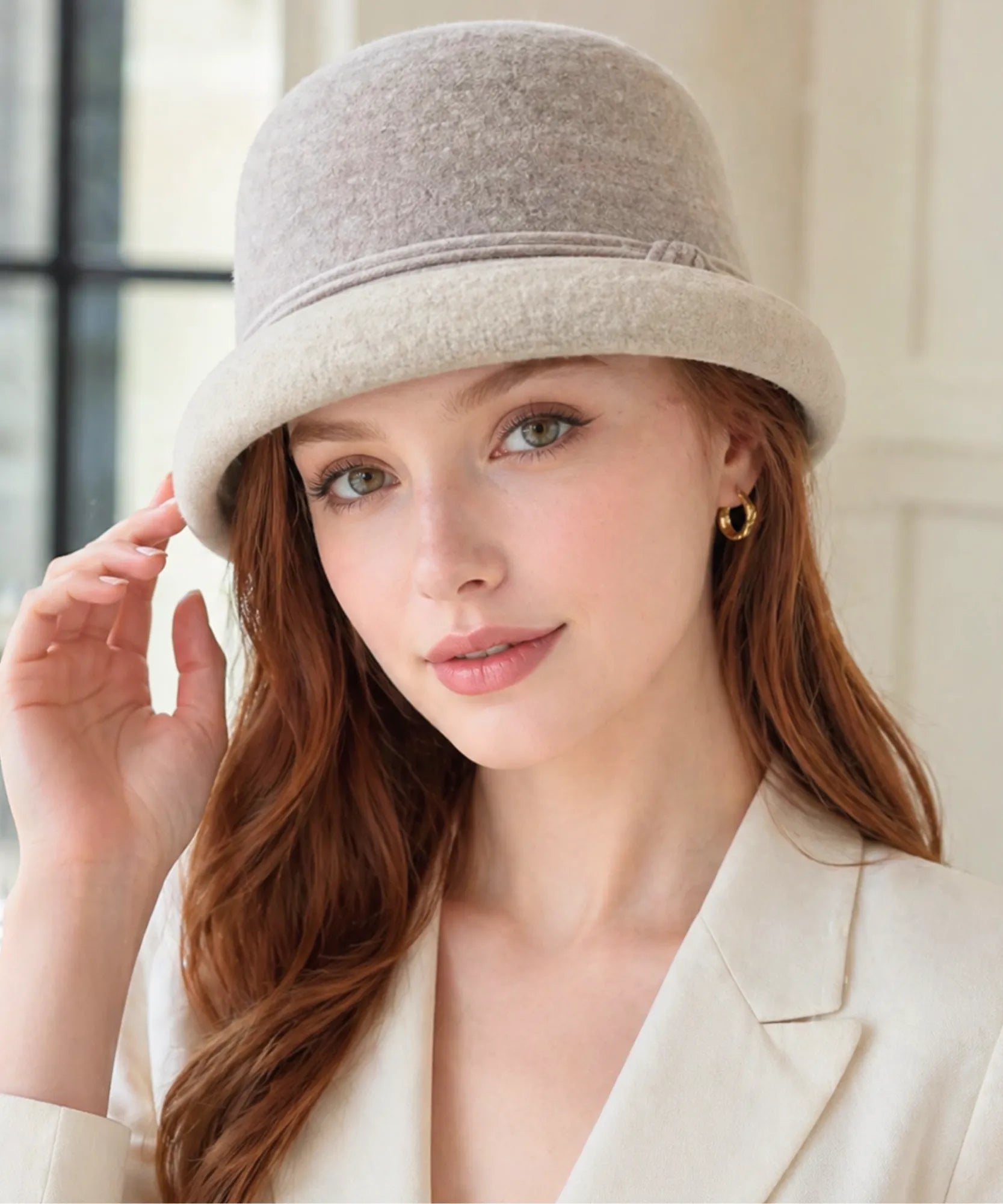 Woman wearing a Women's Wool Felt Cloche Hat in Oatmeal with a striped band and rounded crown