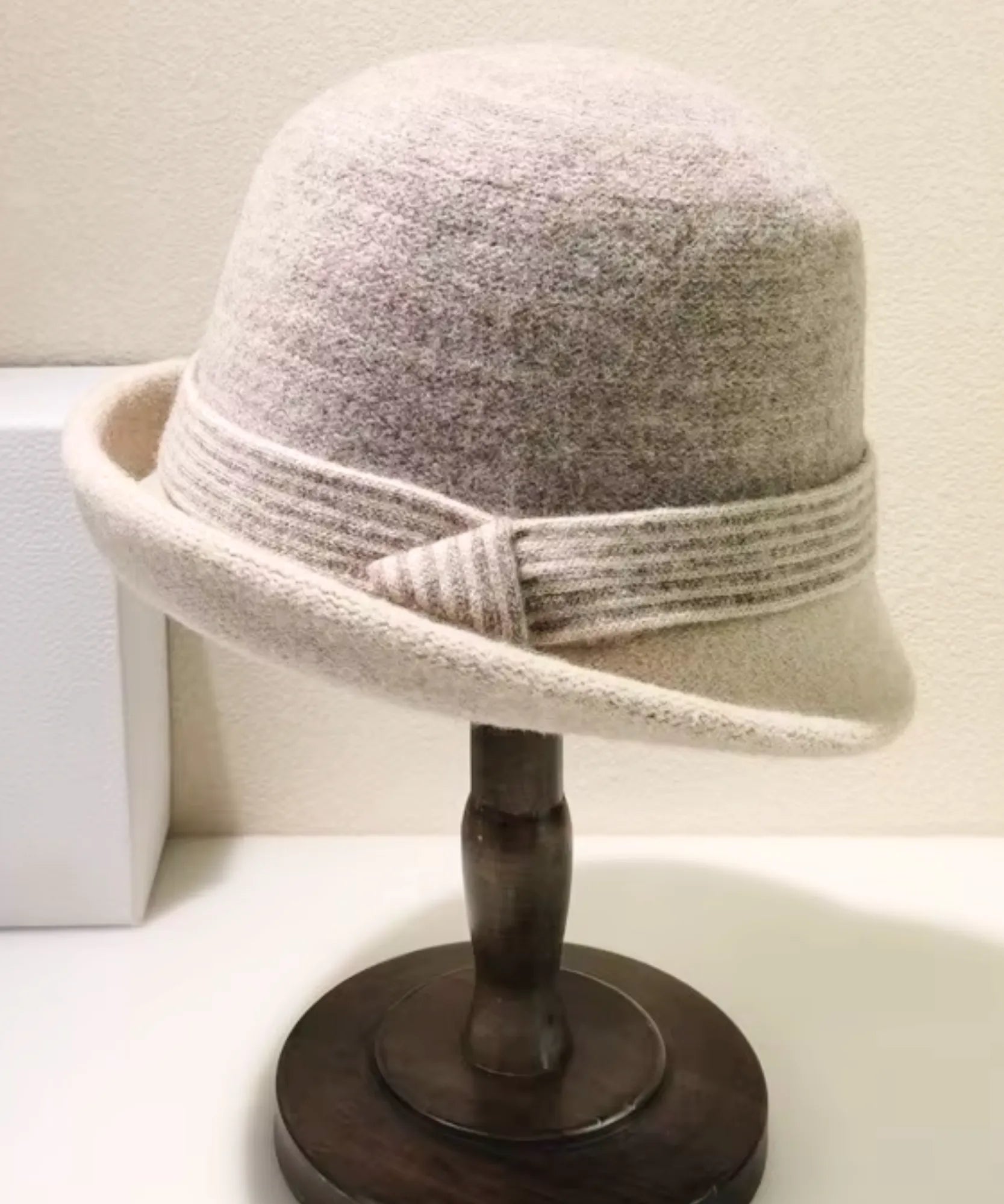 Women's Wool Felt Cloche Hat in Oatmeal with a striped band, displayed on a hat stand