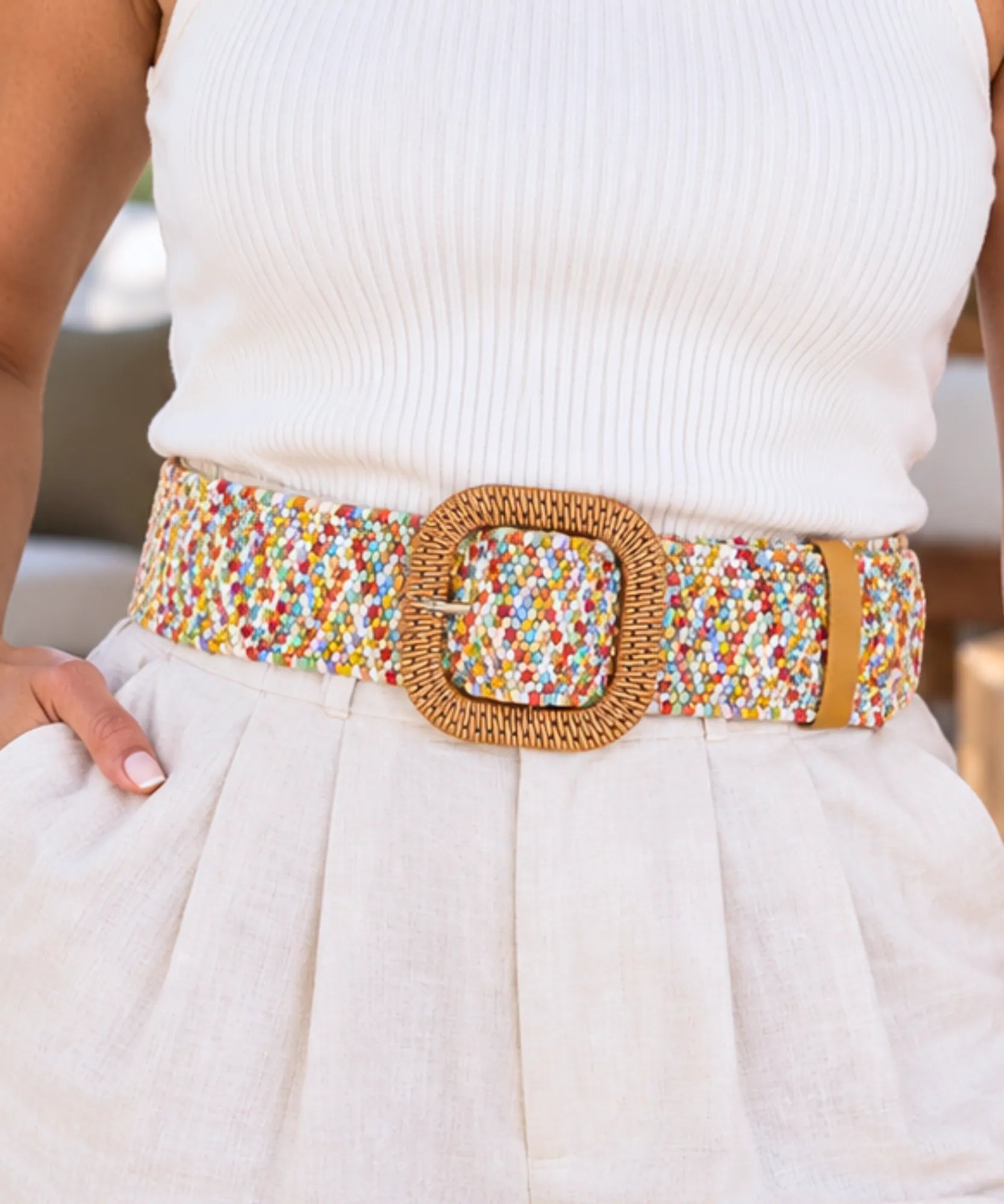 Women's boho belt with pastel woven elastic band and square buckle on a white outfit