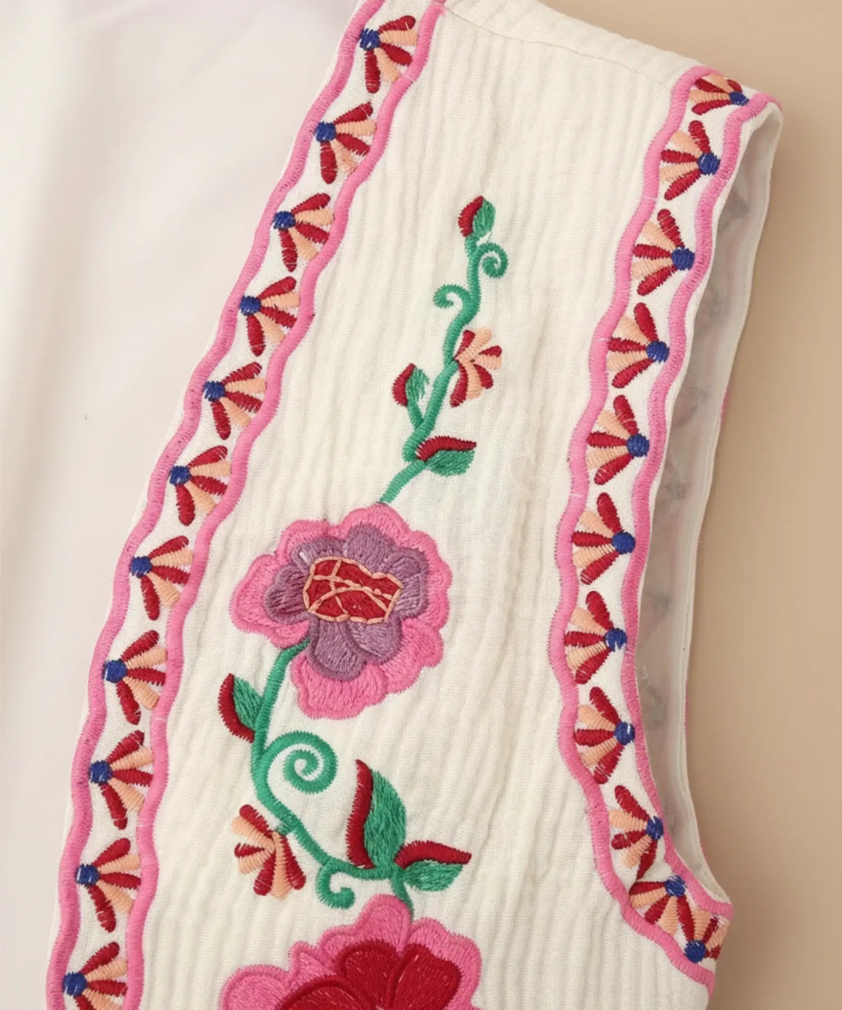 Women's floral embroidered cropped vest in pink, back view