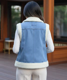 Women's sherpa-lined denim vest in blue, close-up of sherpa lapel