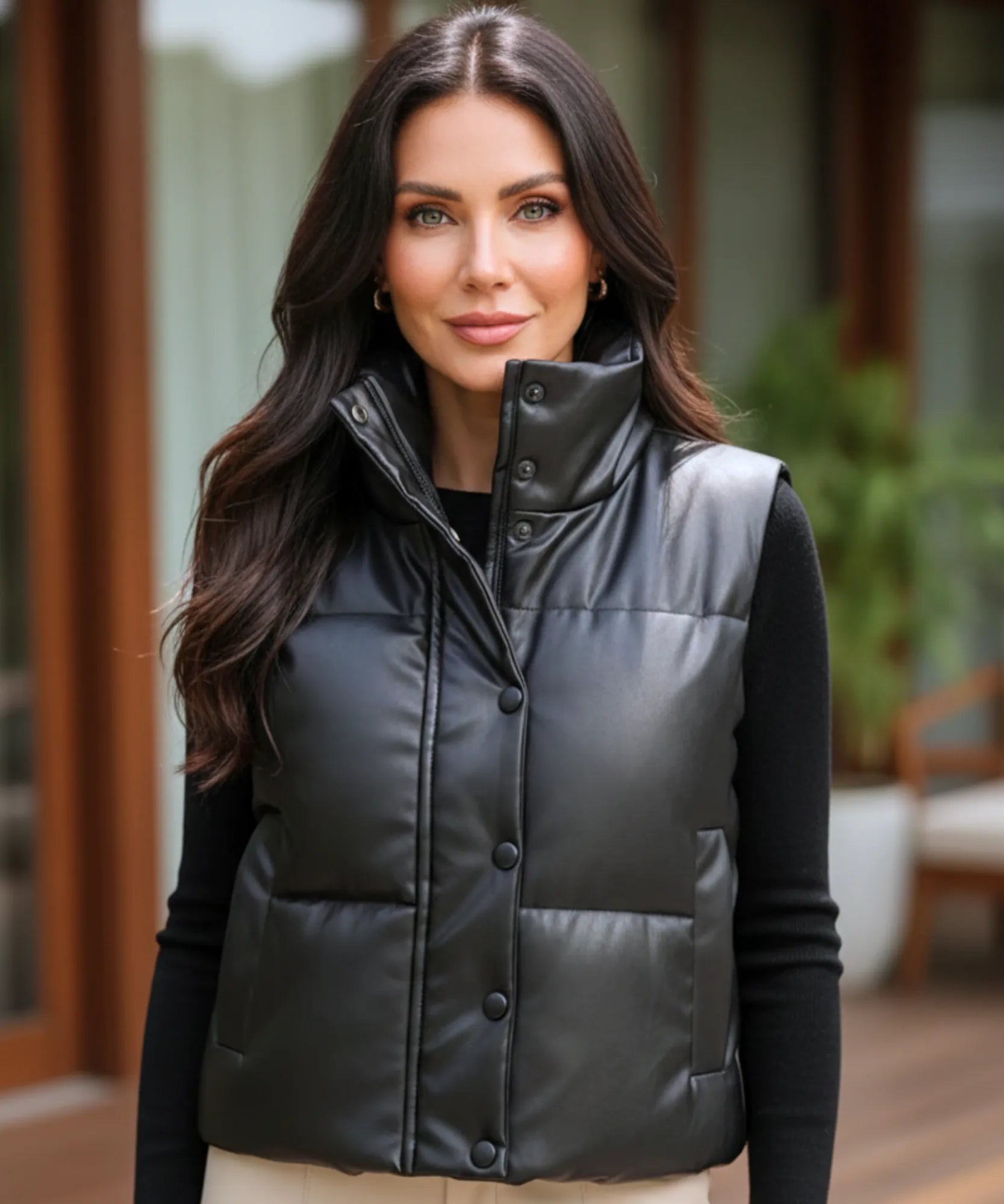 Women's leather puffer vest in black, close-up of high collar