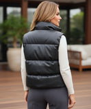 Women's leather puffer vest in black, side view