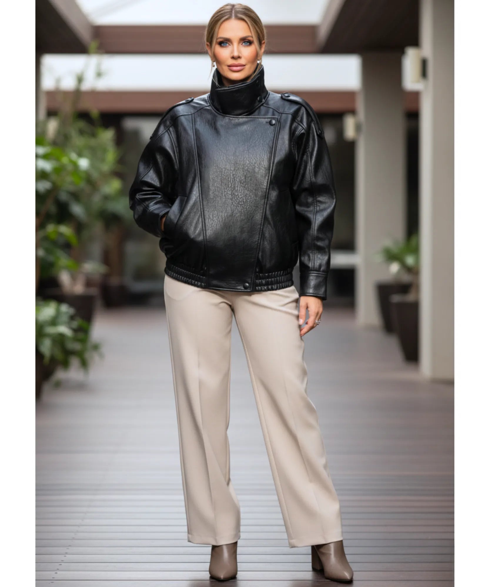 Woman wearing the black leather jacket in an urban setting