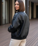 Front view of the black leather jacket with diagonal zip