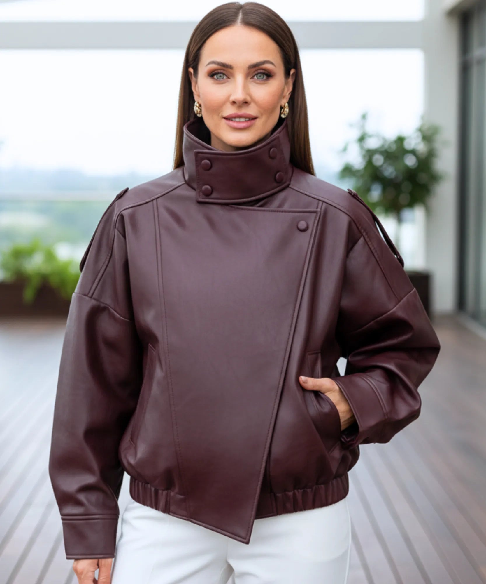 Woman wearing the burgundy leather jacket outdoors