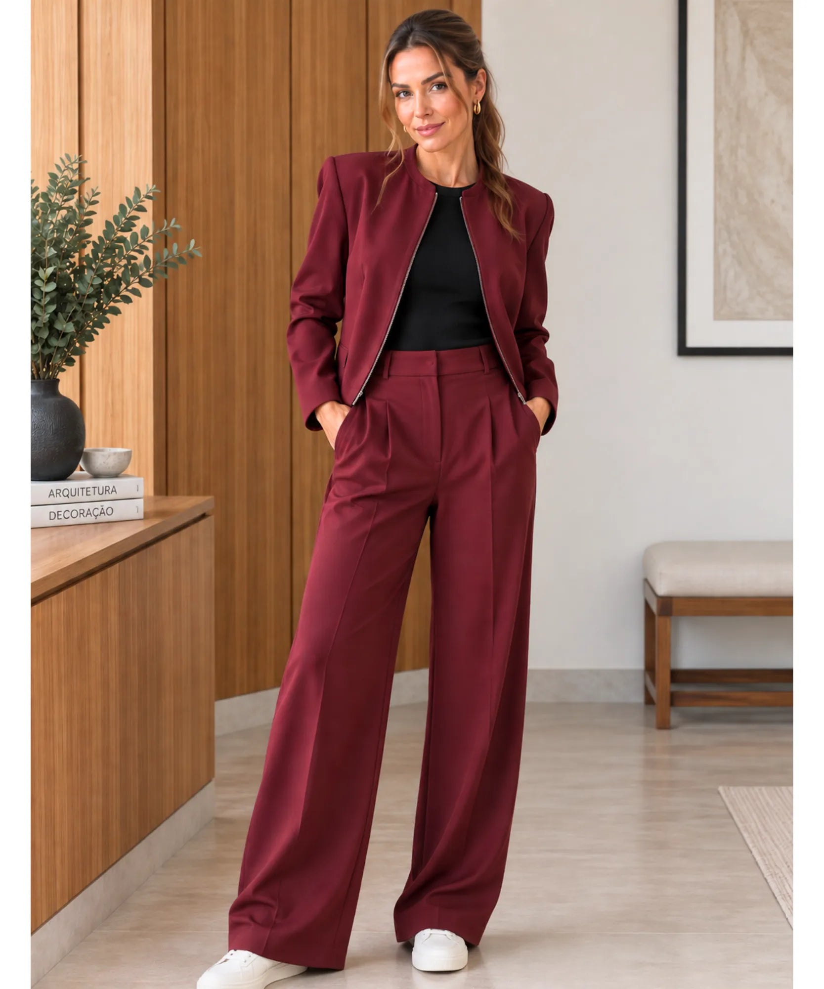 Women's burgundy blazer and pants set styled with white sneakers