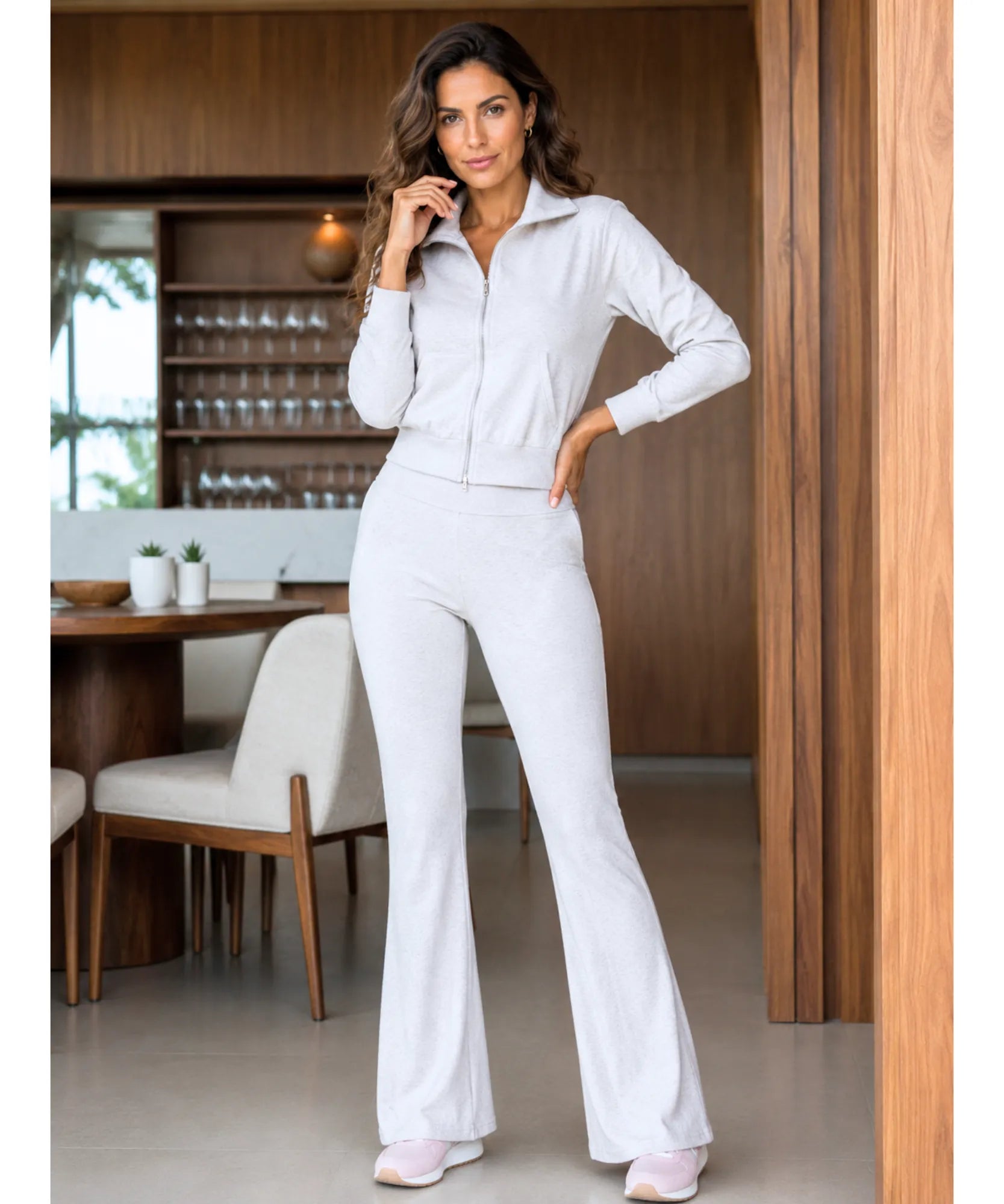 Women's flare sweatpants set in a light grey tone, styled with pink sneakers