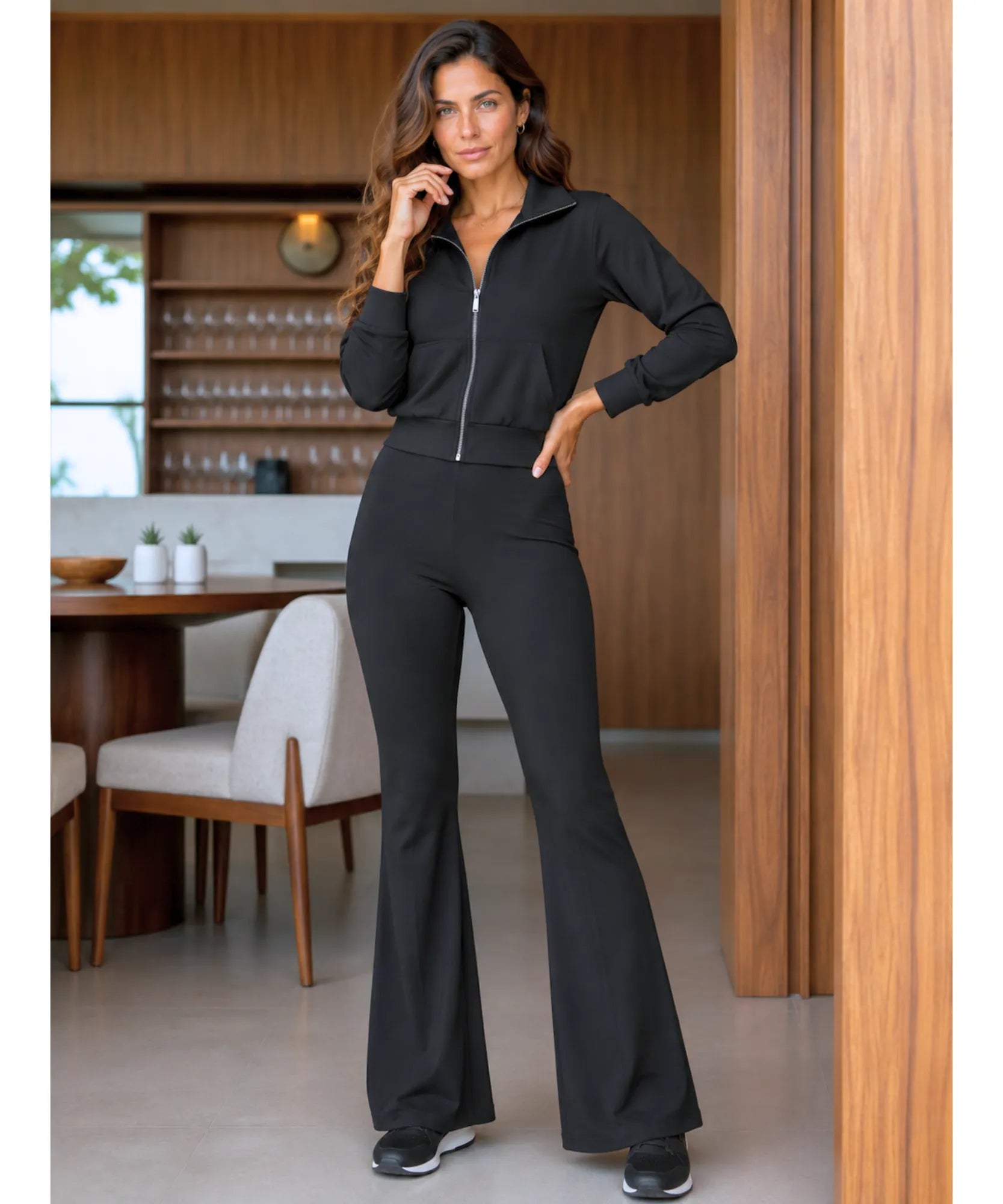 Women's flare sweatpants set in Black, styled with white sneakers