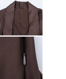 Close-up of the deep V-neck on the tailored pantsuit blazer