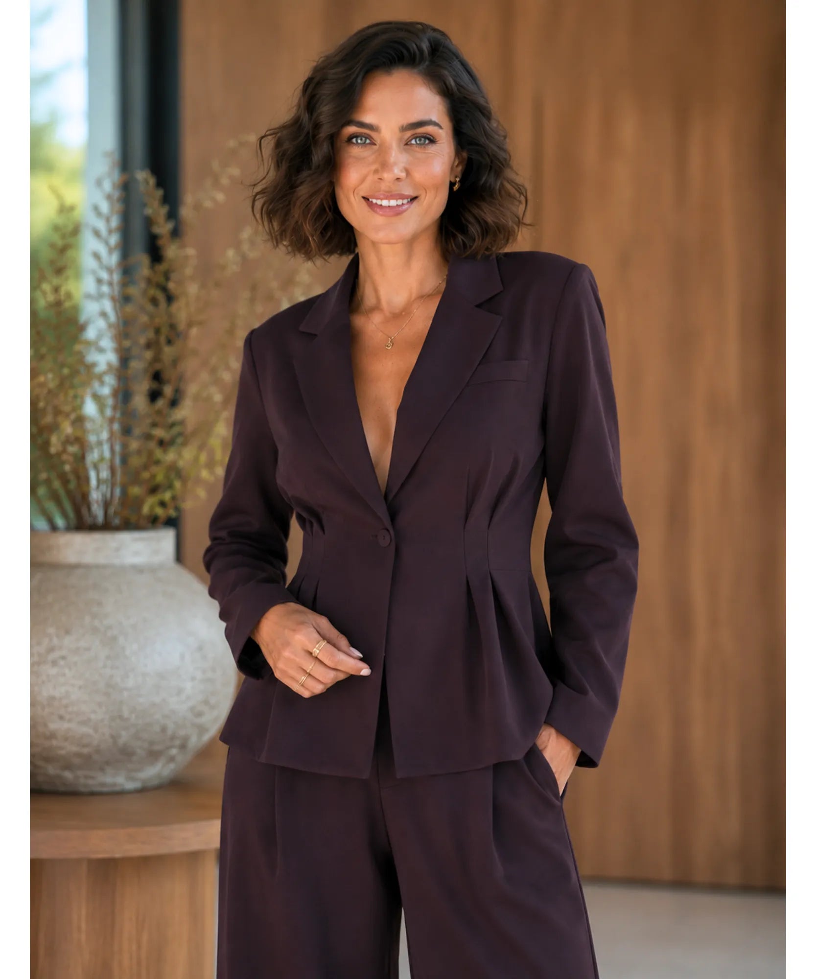 Women's brown tailored pantsuit with a deep V-neck blazer