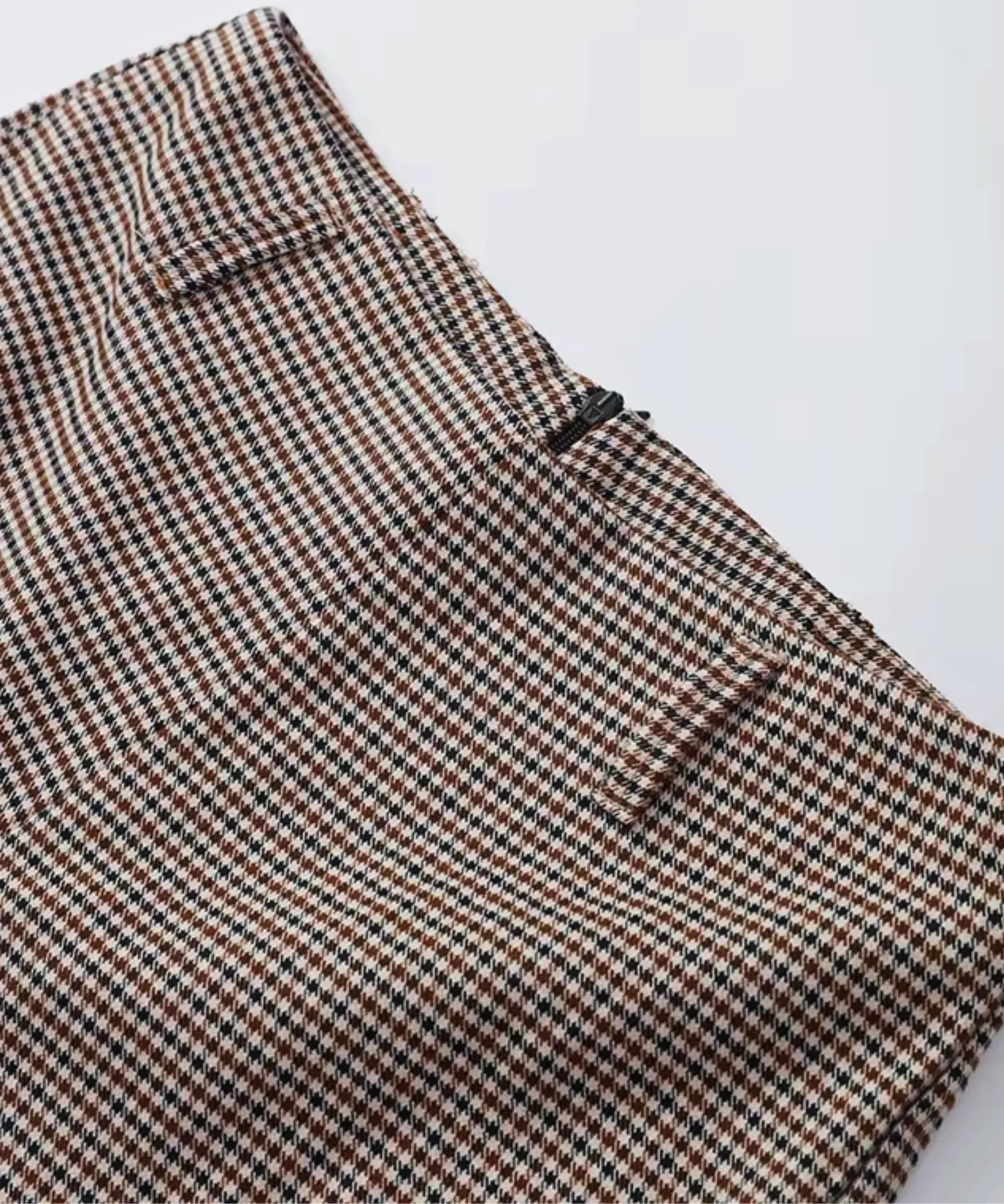 Close-up of the houndstooth shorts with a side zip and belt loops