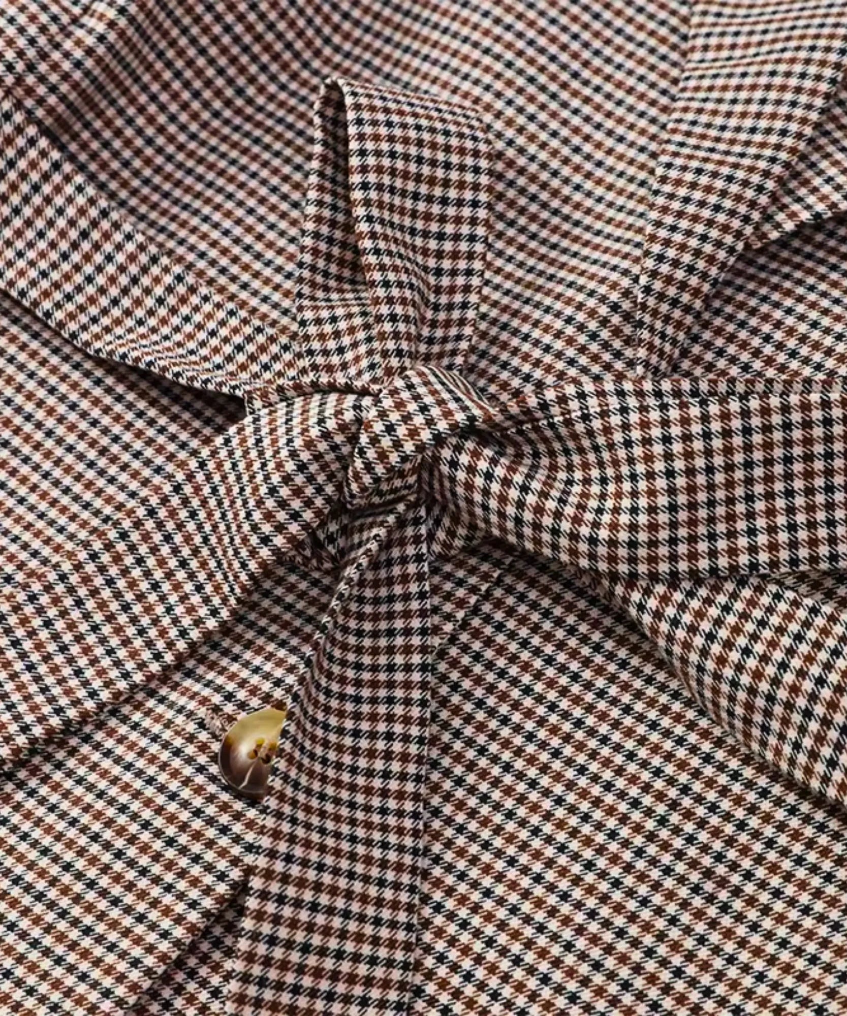 Close-up of the houndstooth check fabric and the tie-waist bow
