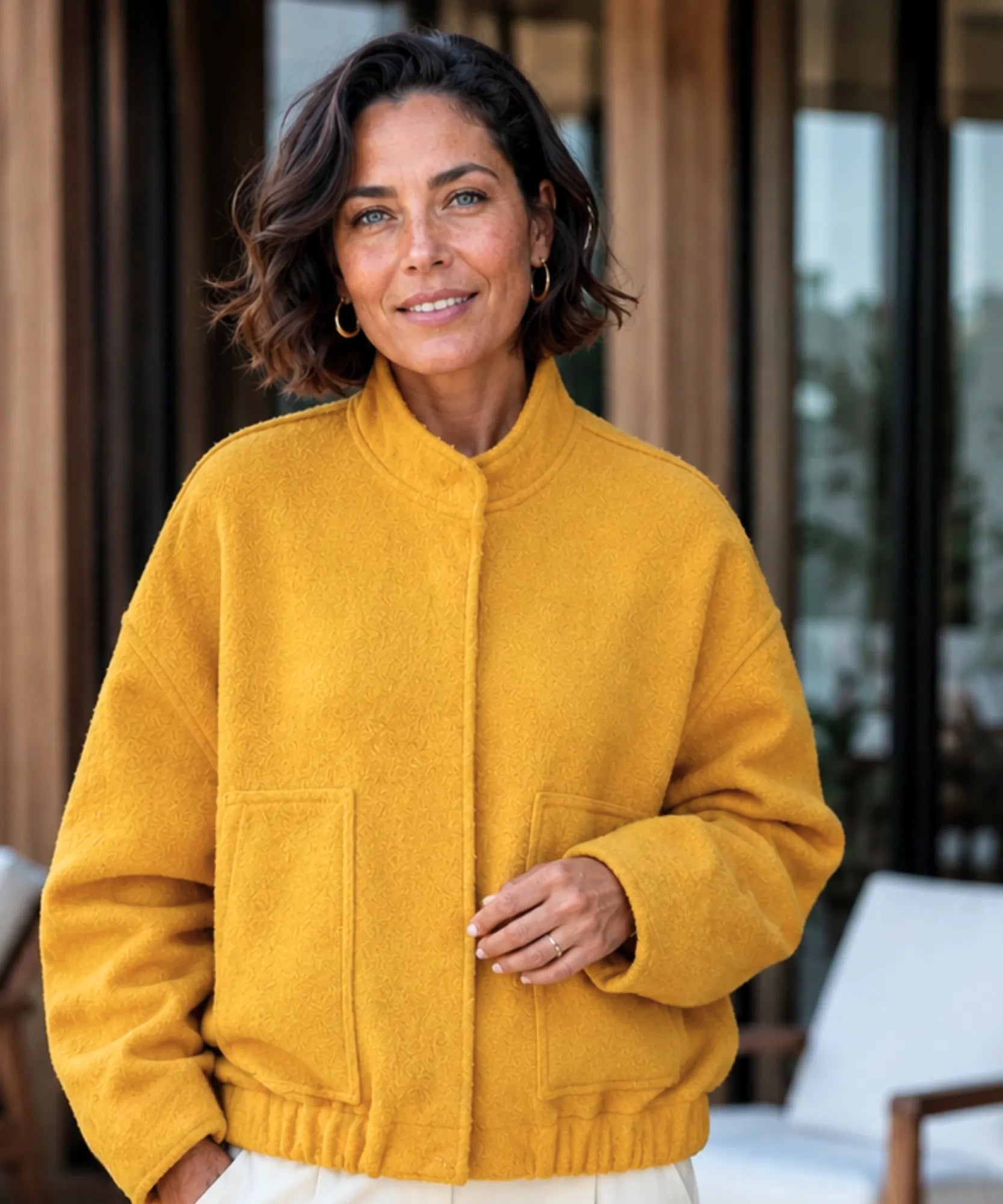 Woman wearing an oversized boucle bomber jacket in yellow