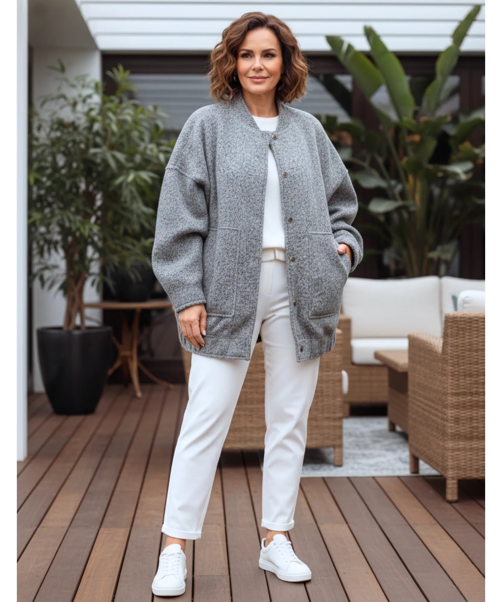 Woman wearing an oversized boucle bomber jacket in charcoal