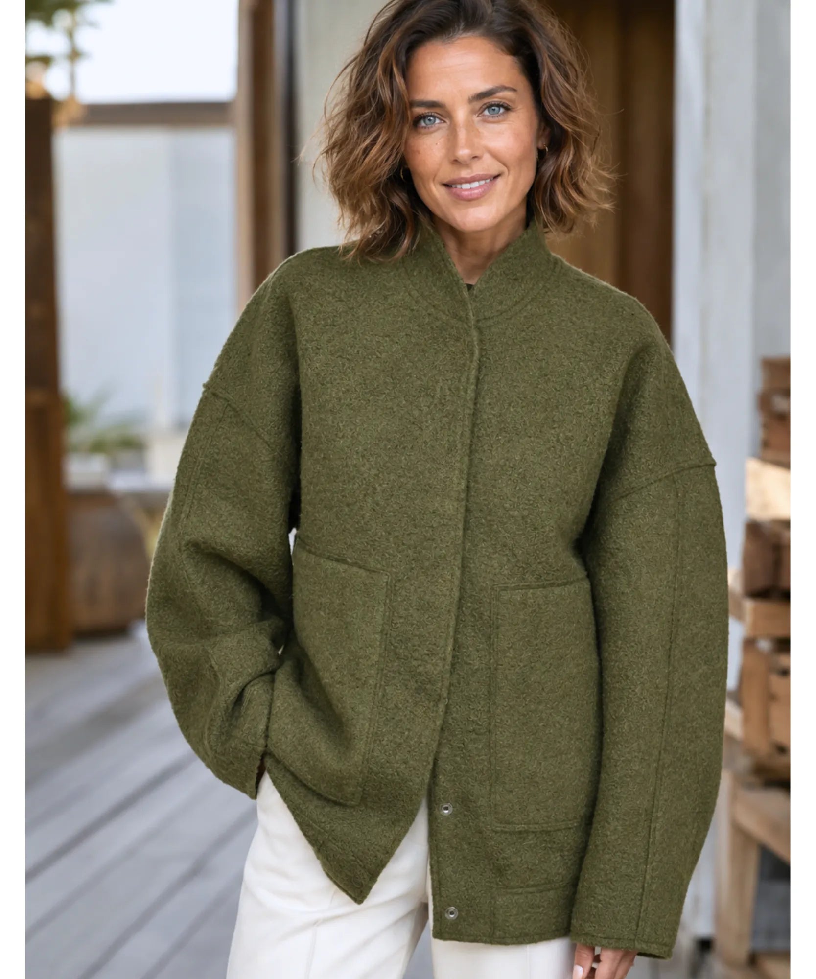 Close-up of the olive green boucle bomber jacket texture