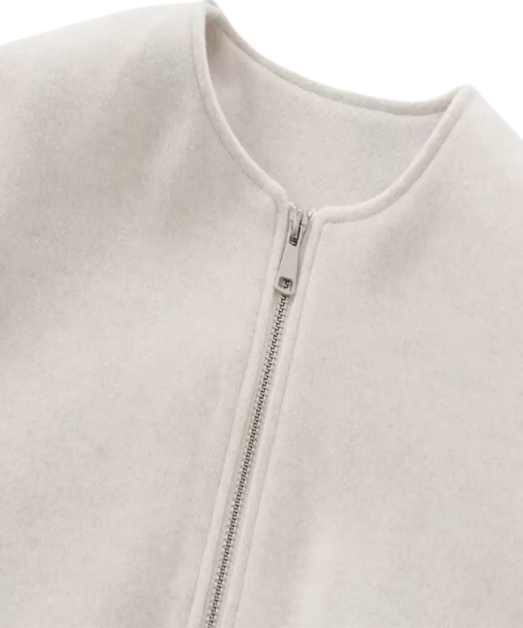 Close-up of the white wool bomber jacket and balloon sleeve