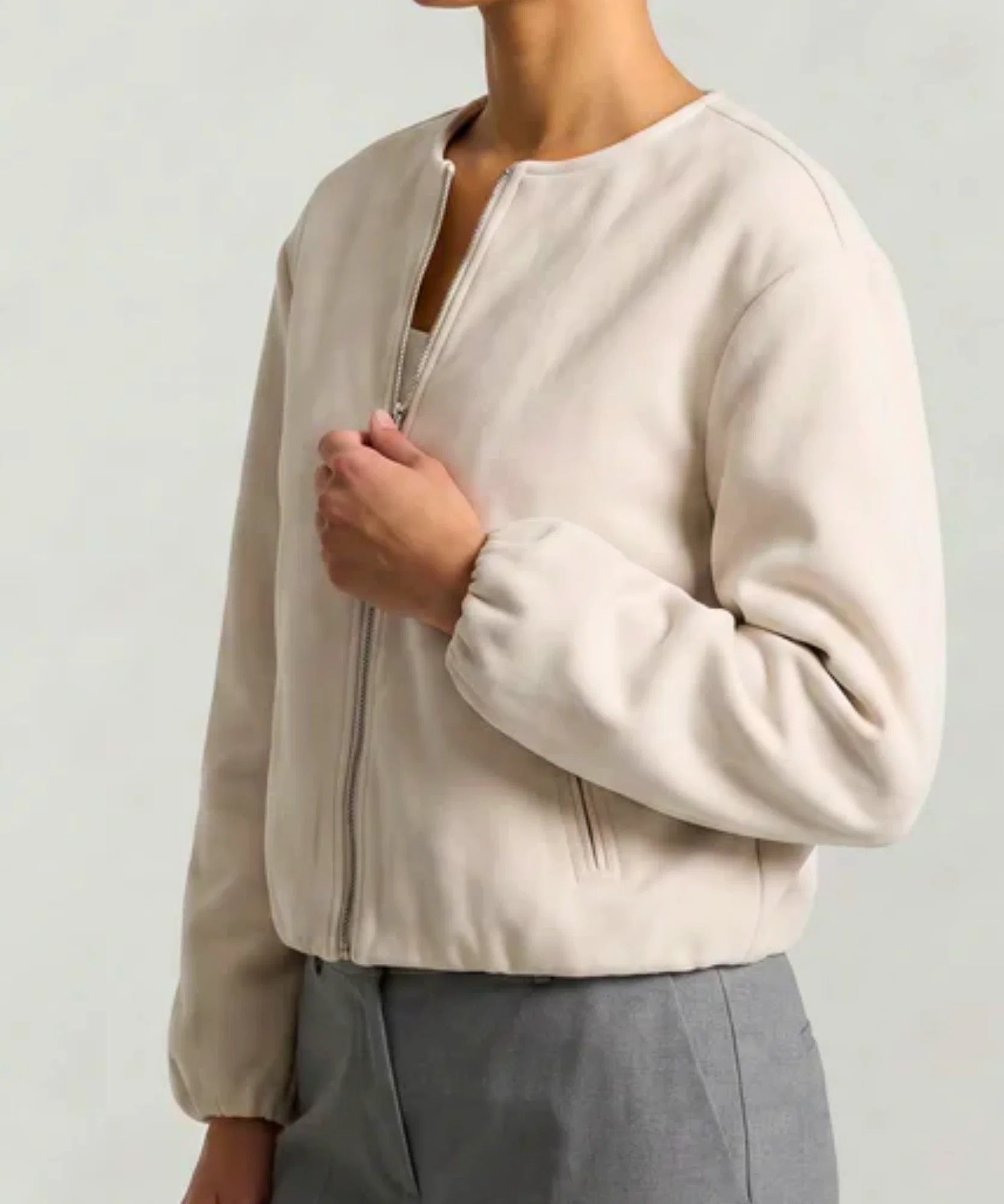 Woman styling the olive green wool bomber jacket with jeans