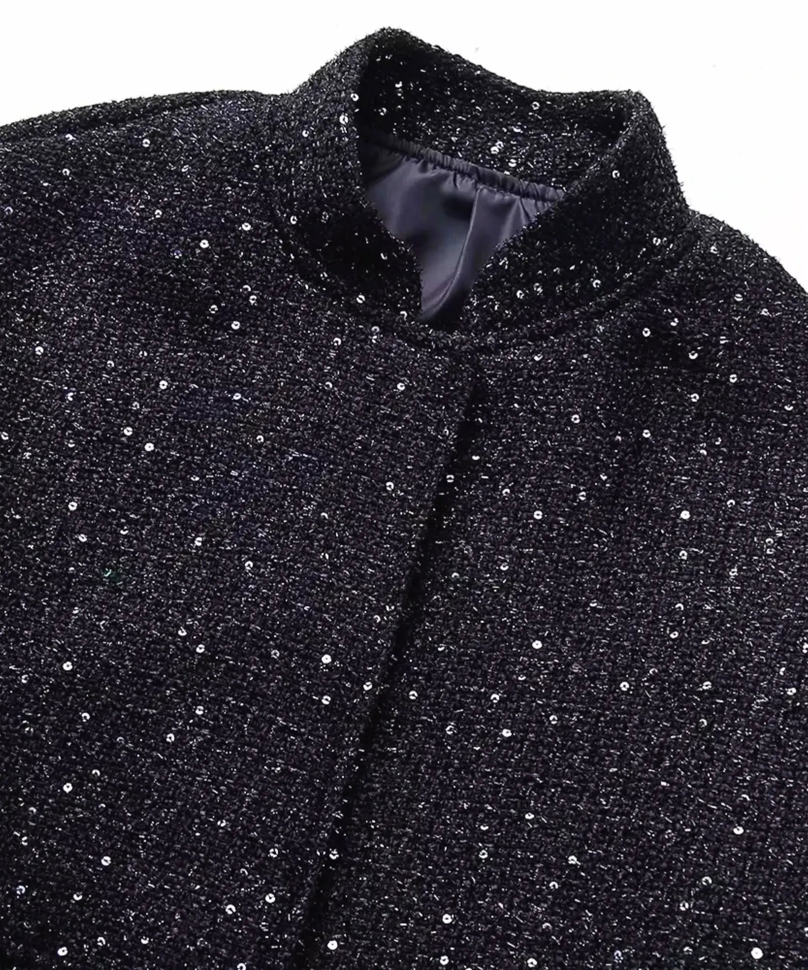 Women's black sequin bomber jacket, close-up of sequin detail