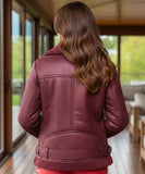 Close-up of the burgundy leather jacket's shearling collar
