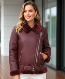 Woman wearing a shearling leather jacket in burgundy