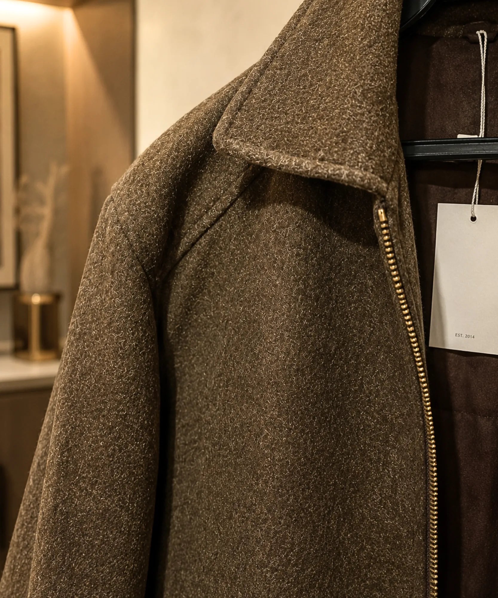 Close-up of the structured collar on the ivory wool jacket