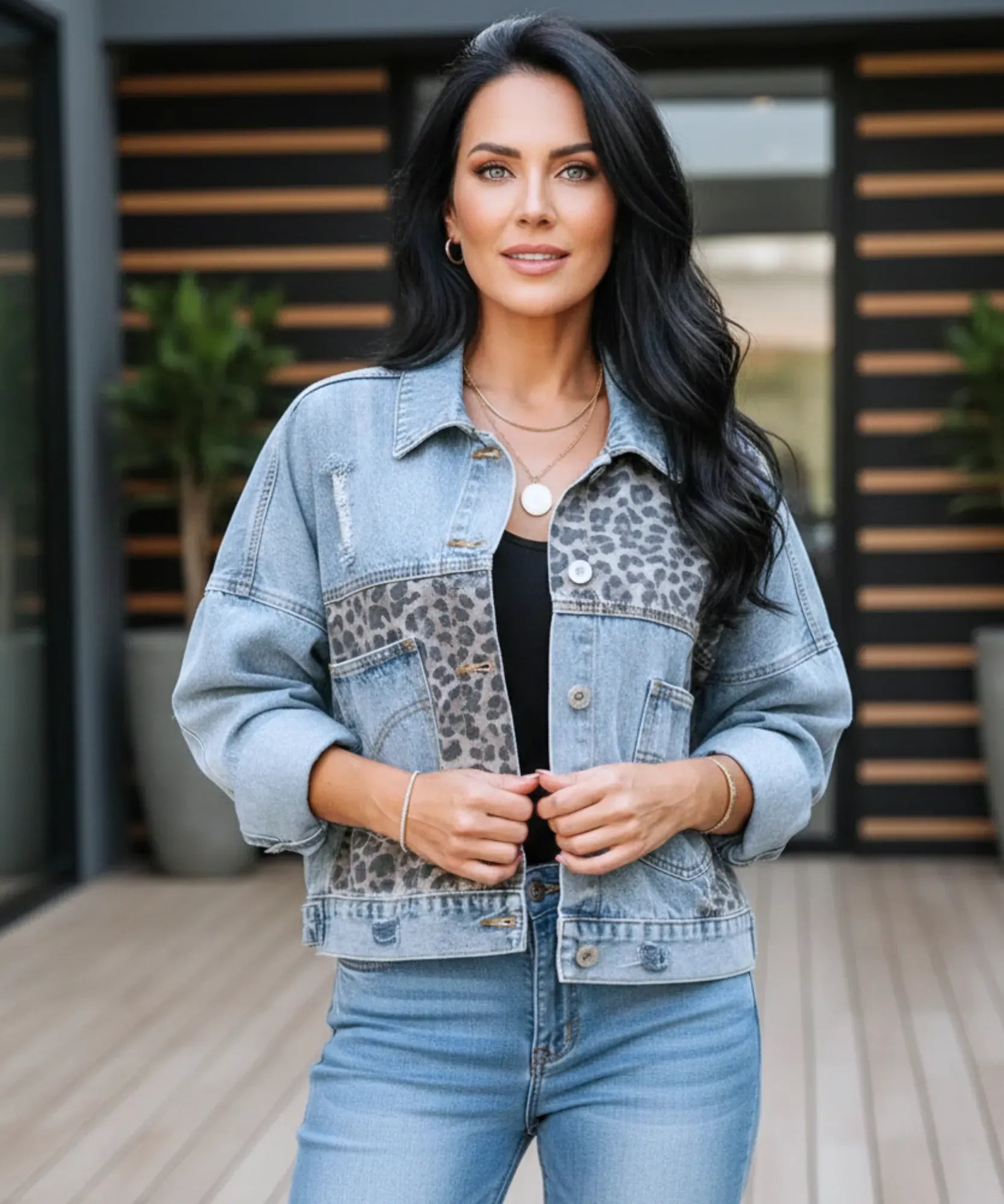 Woman styling the leopard print denim jacket over a dress