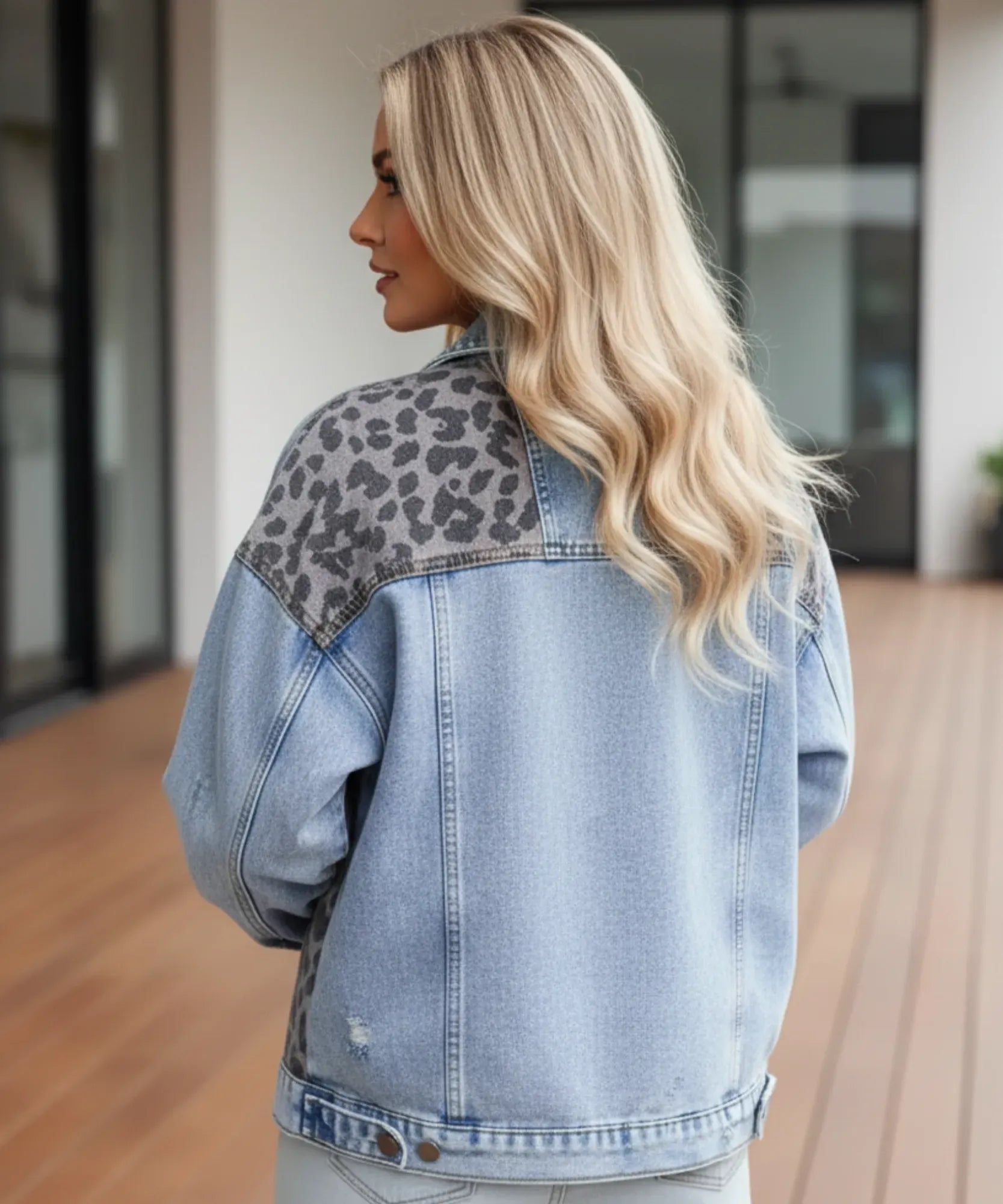Detail of the double button closure on the denim jacket