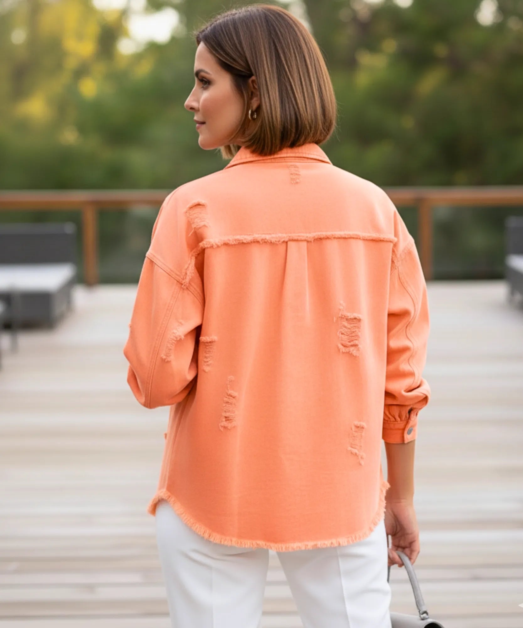 Women's orange distressed oversized denim jacket, detail view