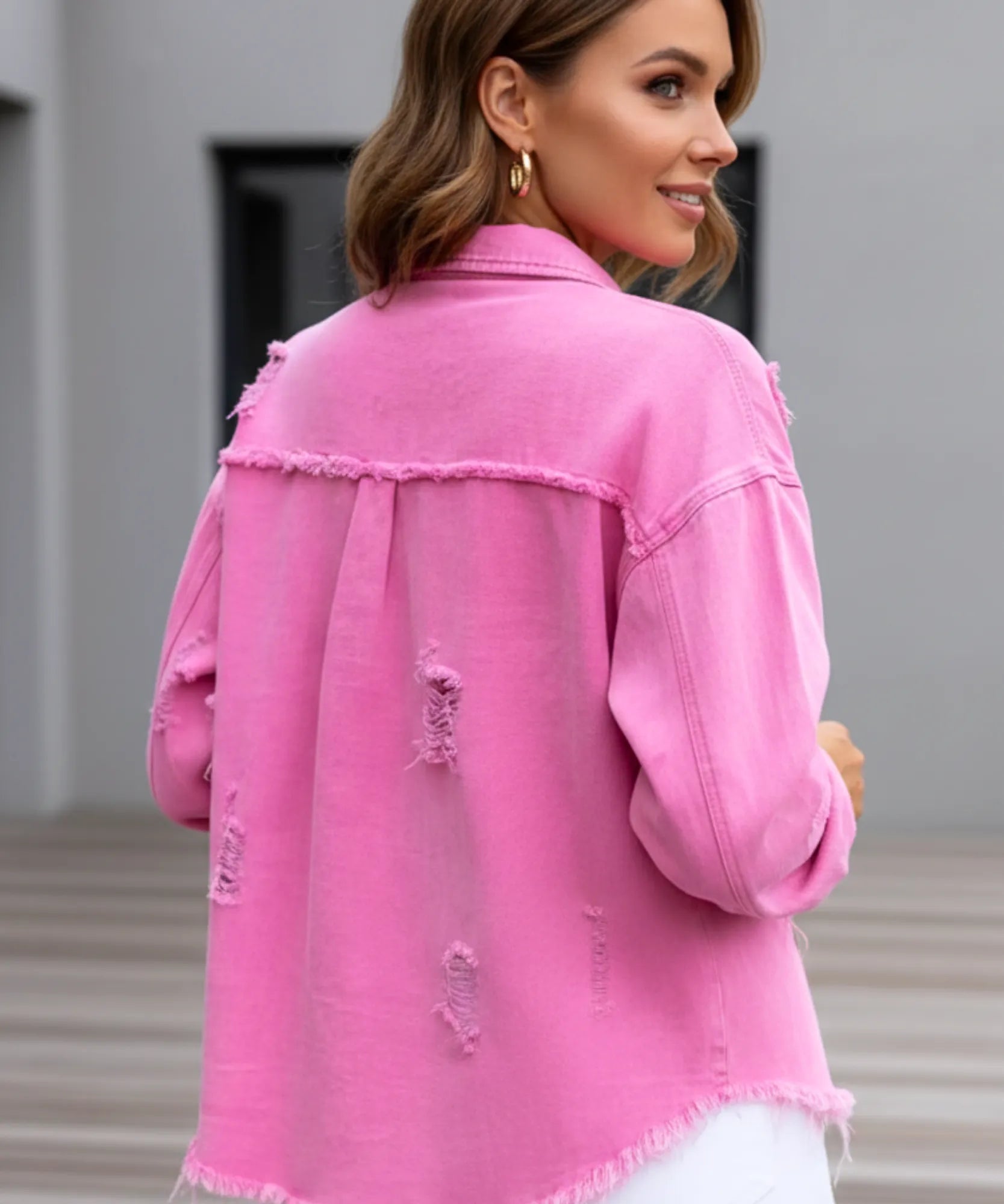 Women's pink distressed oversized denim jacket, front view