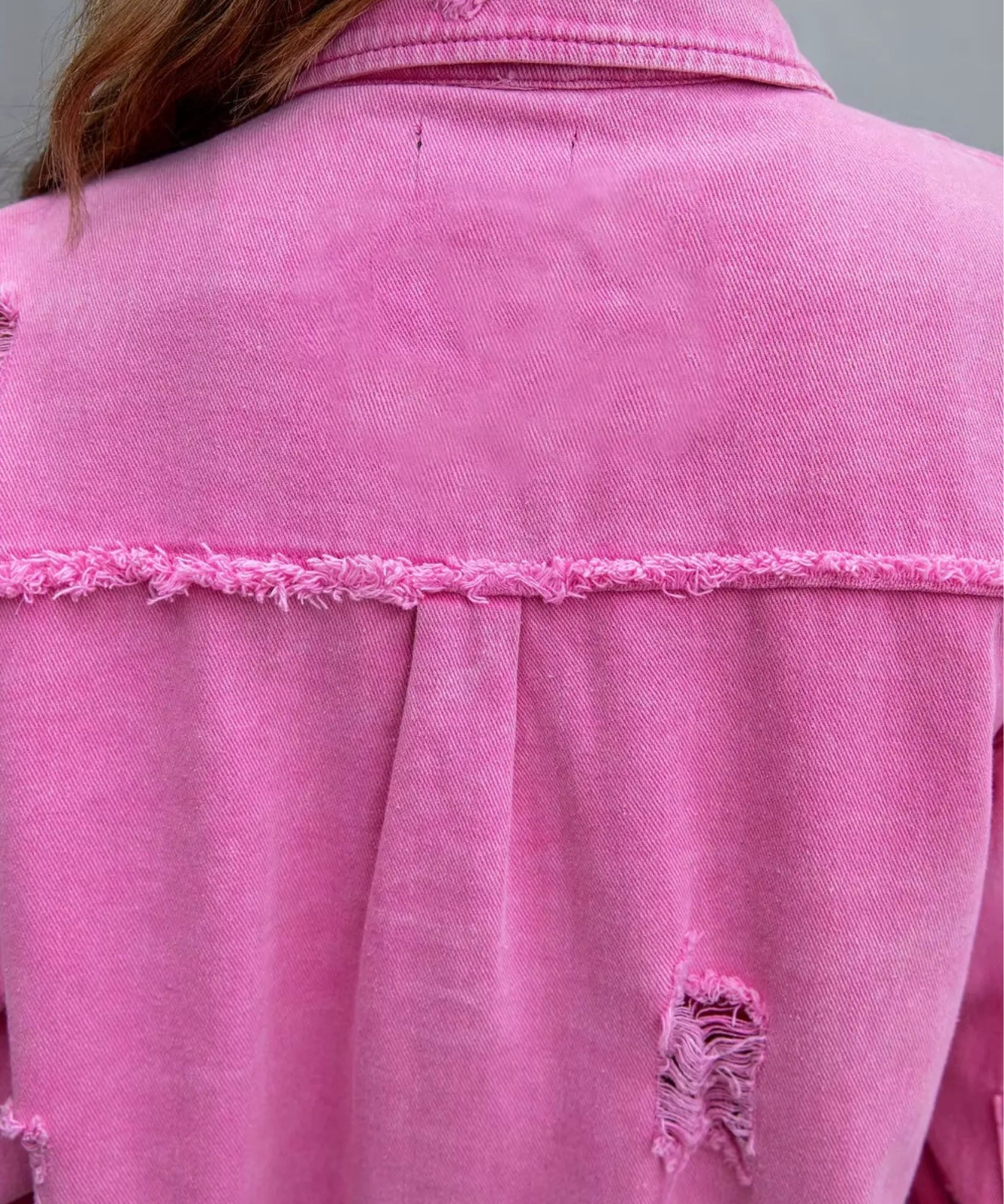 Women's pink distressed oversized denim jacket, detail view