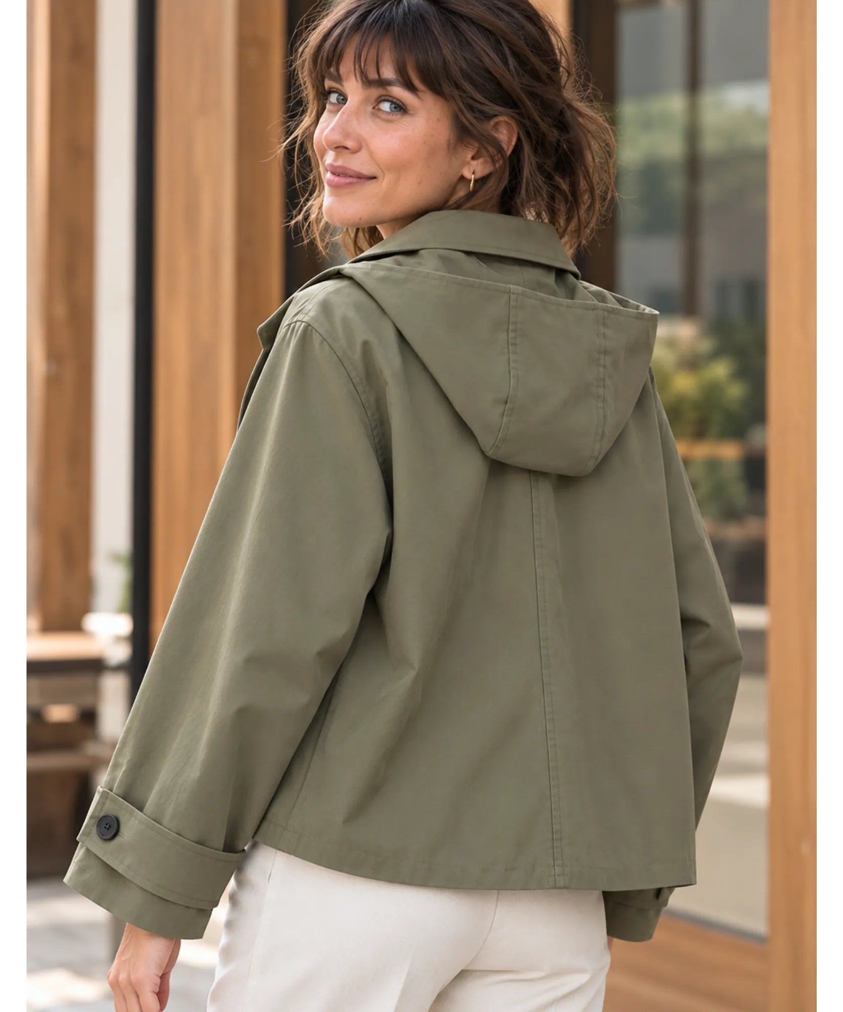 Women's utility jacket in olive green, back view with hood