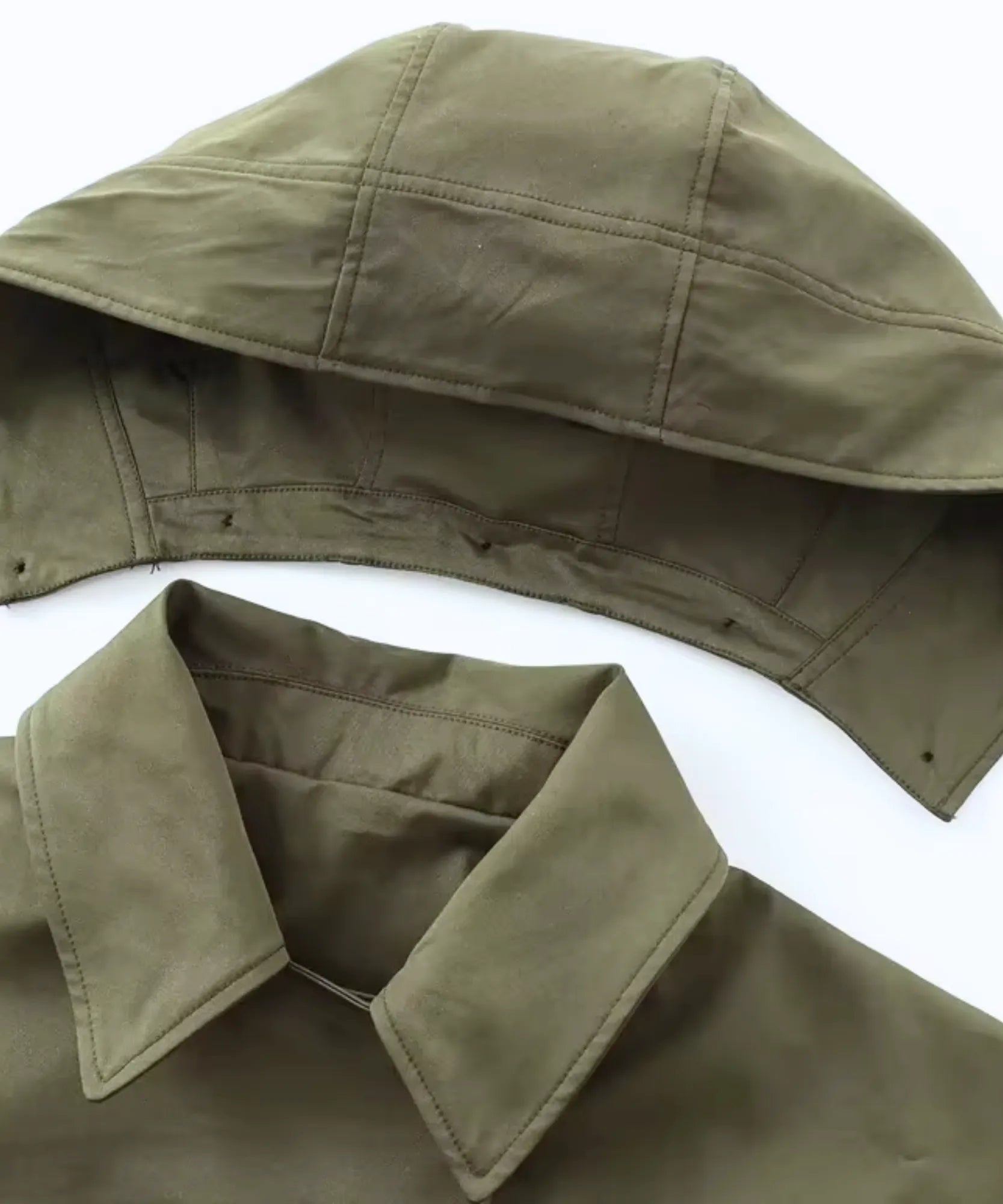 Women's utility jacket in olive green showing the button-on hood detail