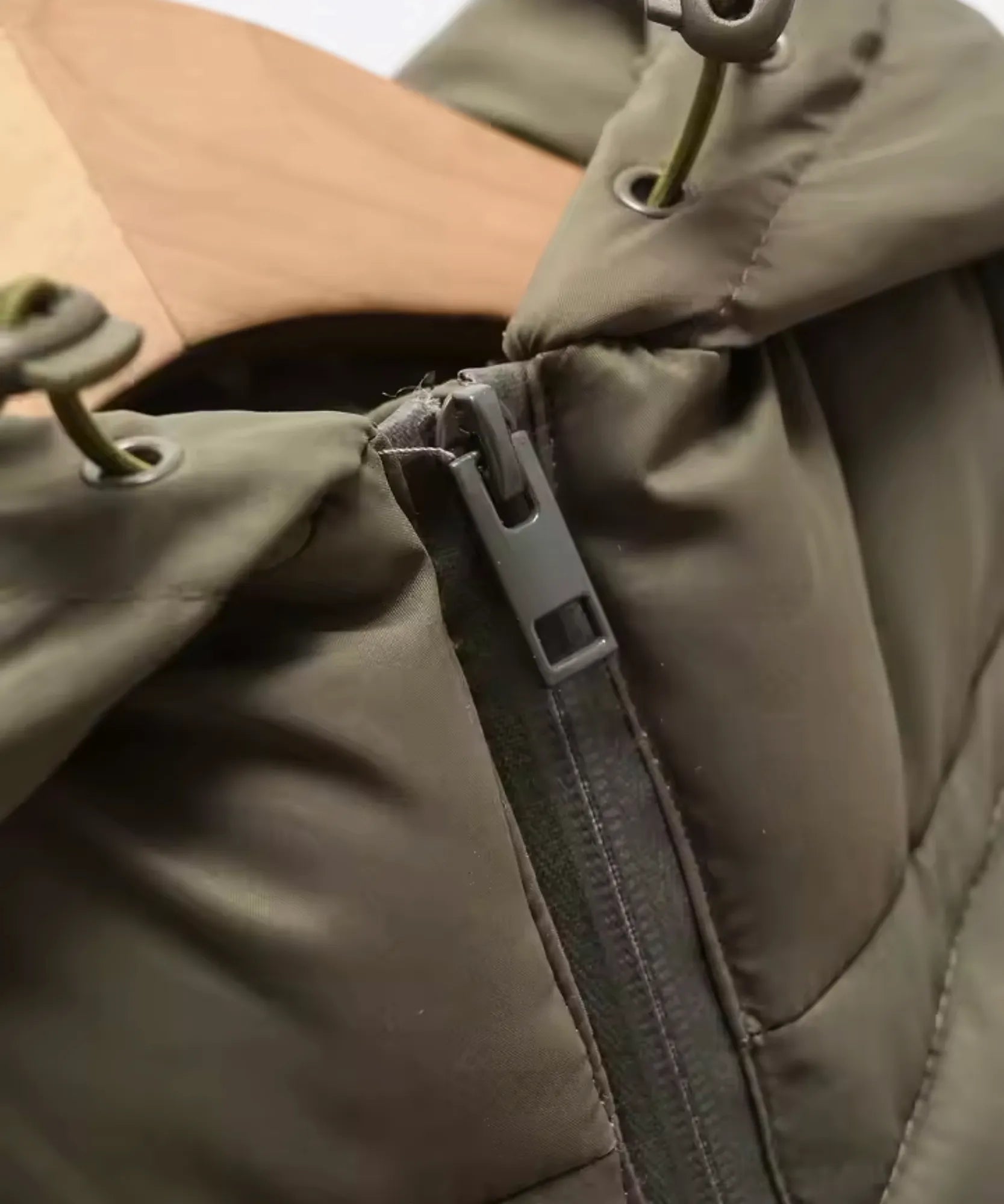 Women's waterproof puffer jacket in olive green, detail view