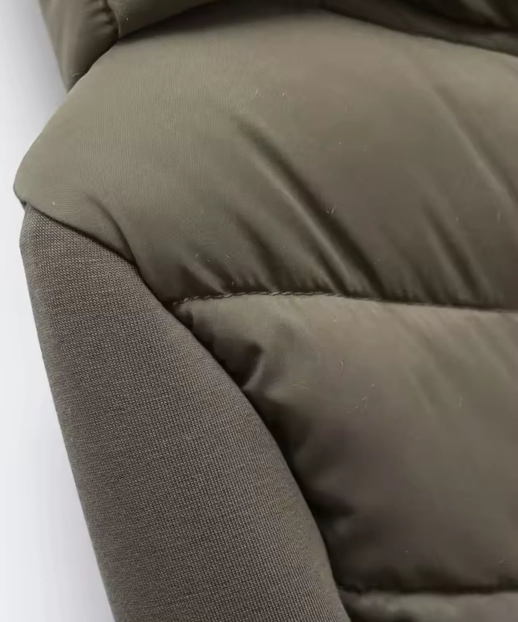 Women's waterproof puffer jacket in olive green, side view