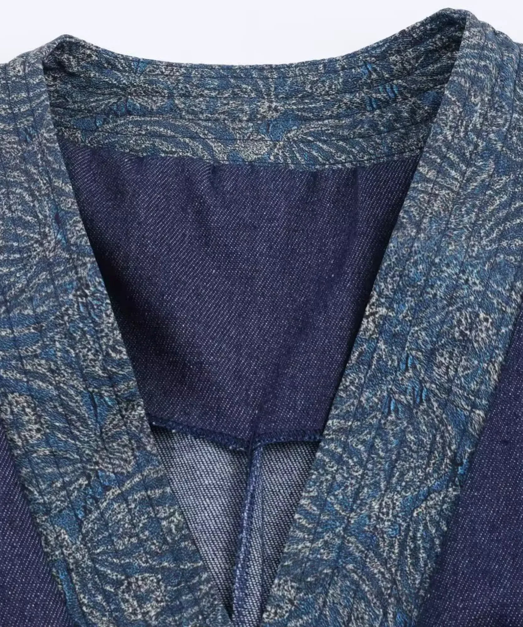 Close-up of floral jacquard wrap collar on a women's denim kimono jacket