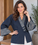 Women's navy denim kimono jacket with wide sleeves and hand on hip