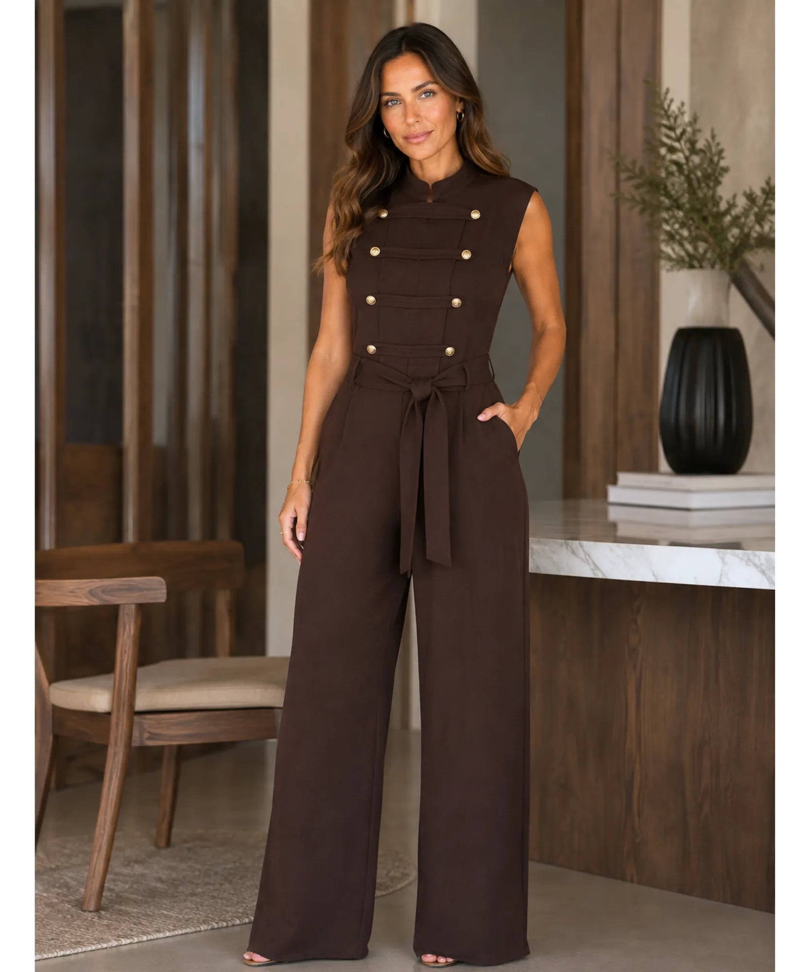 Women's sleeveless brown jumpsuit styled in an office setting
