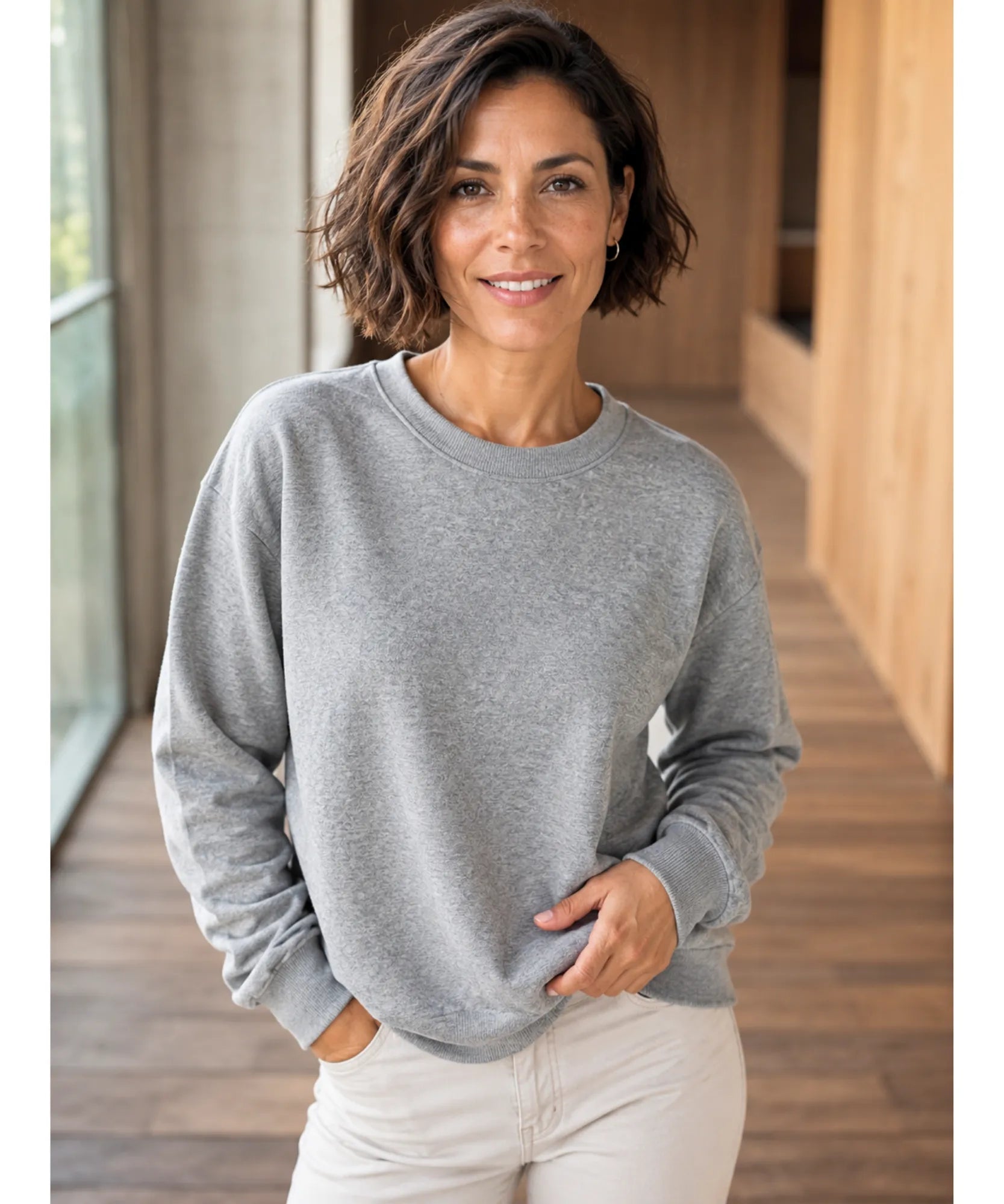 Women's light grey fleece lined sweatshirt styled with cream pants