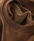 Close-up of the ribbed crew neck on a women's camel fleece lined sweatshirt