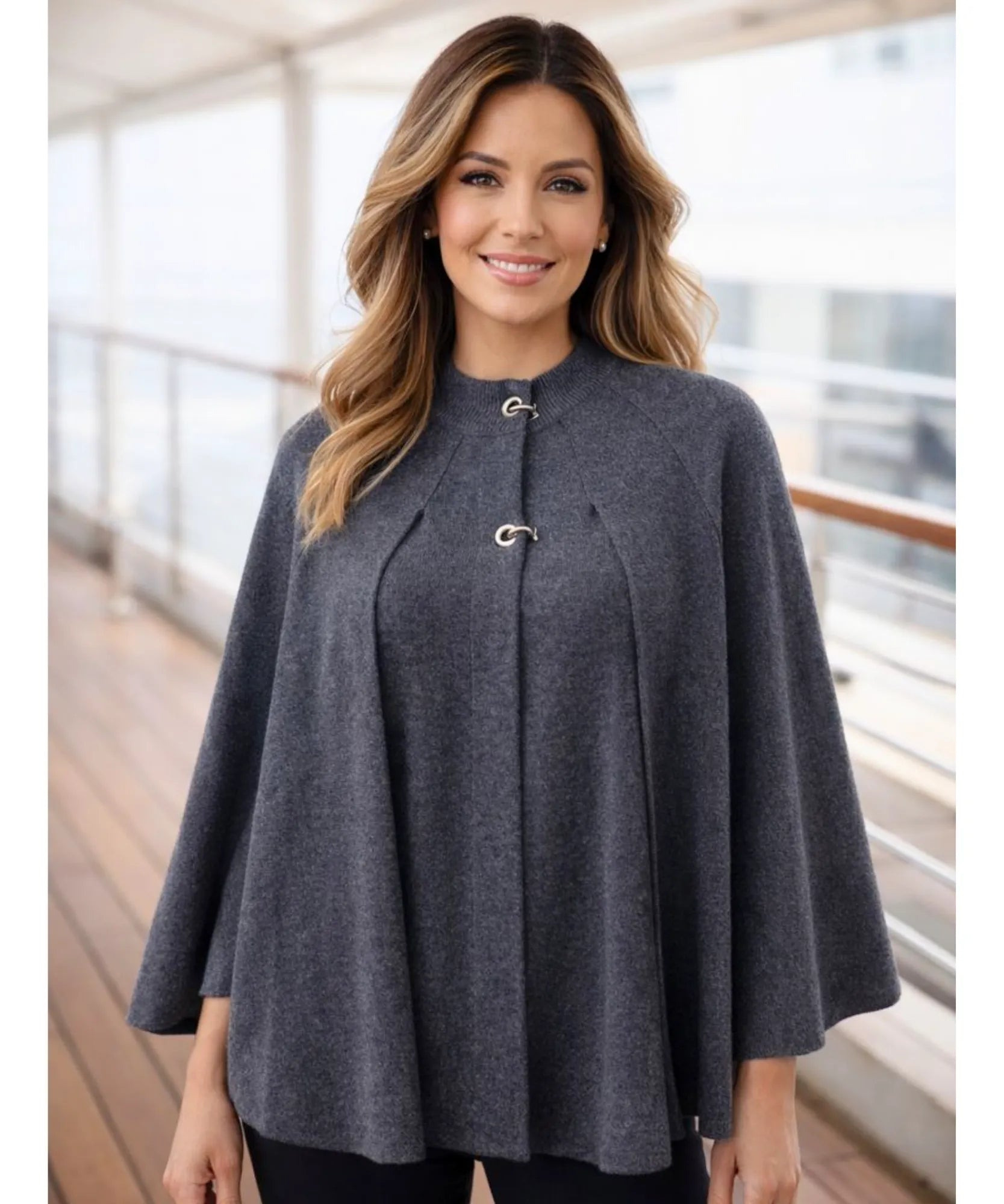 Women's charcoal knit poncho with toggle clasps, close-up detail