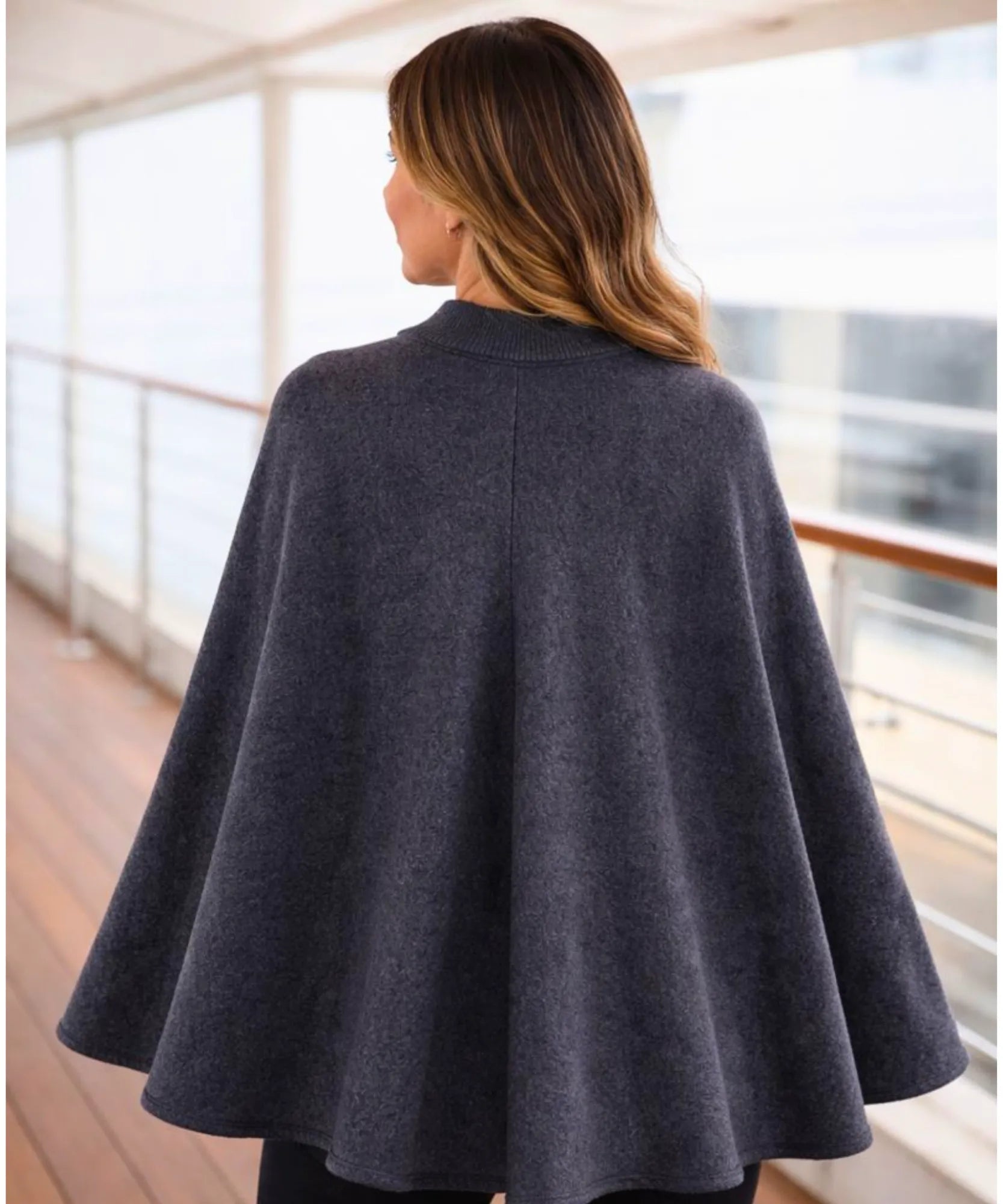 Women's charcoal knit poncho with toggle clasps, side view