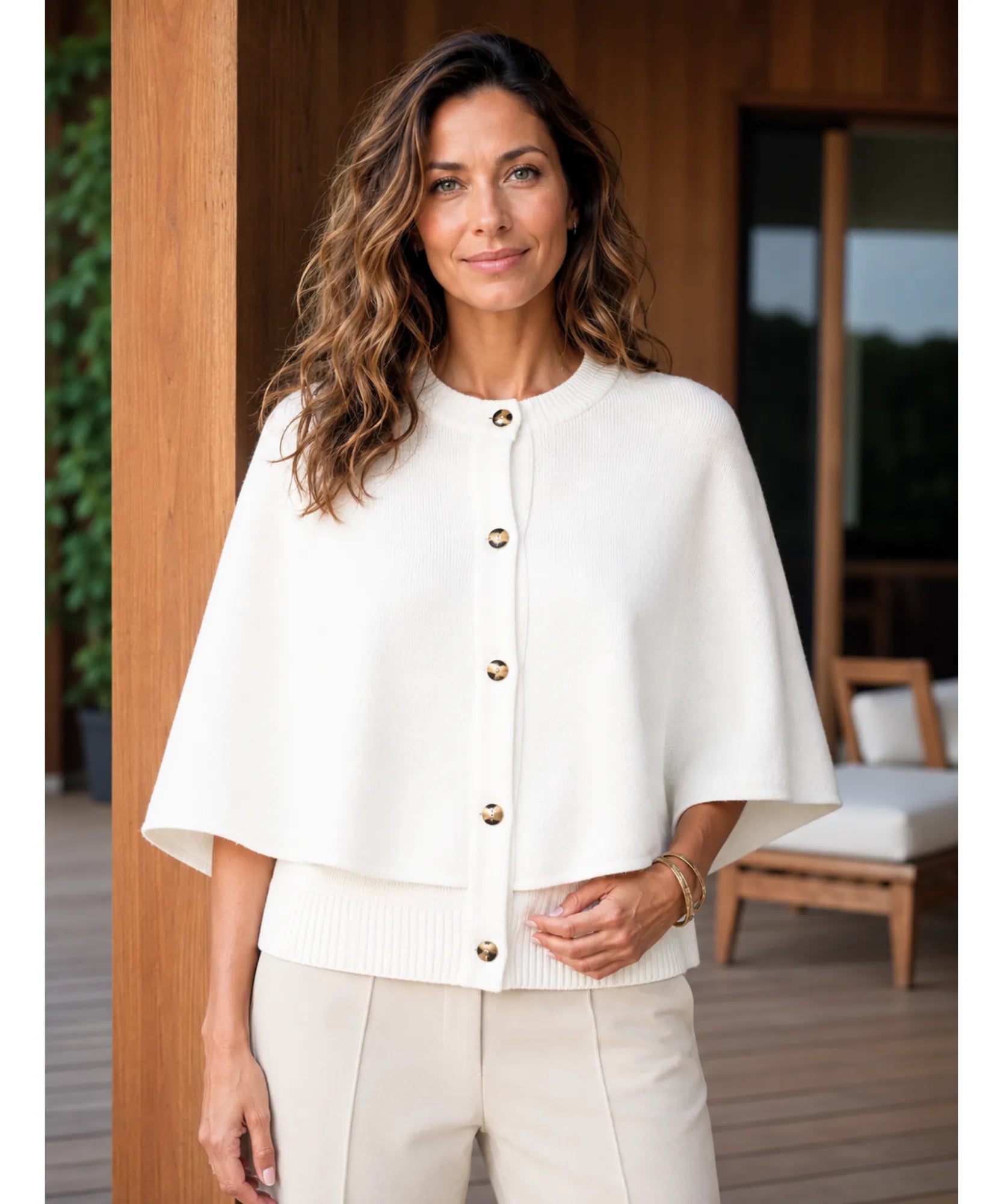 Women's cashmere-soft sweater cape in ivory, styled indoors