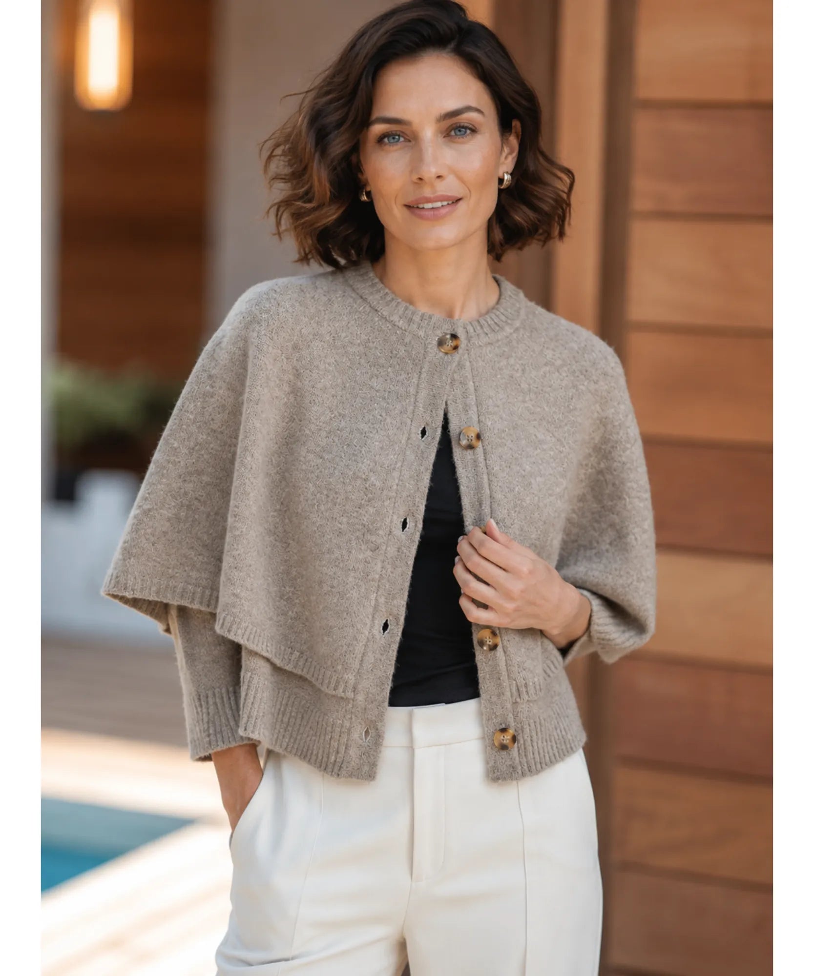 Women's cashmere-soft sweater cape in taupe, styled indoors