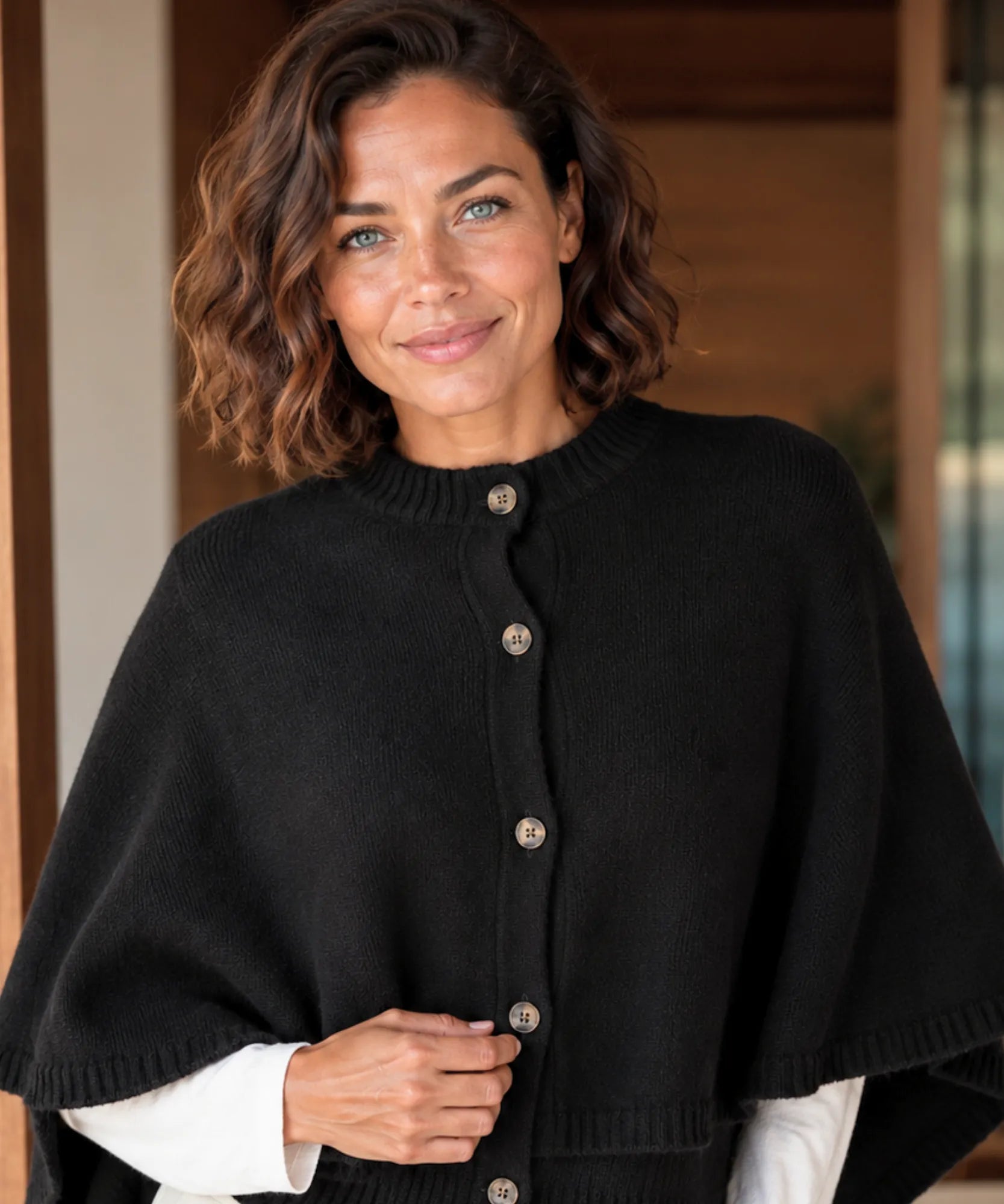 Women's cashmere-soft sweater cape in black with button front, front view
