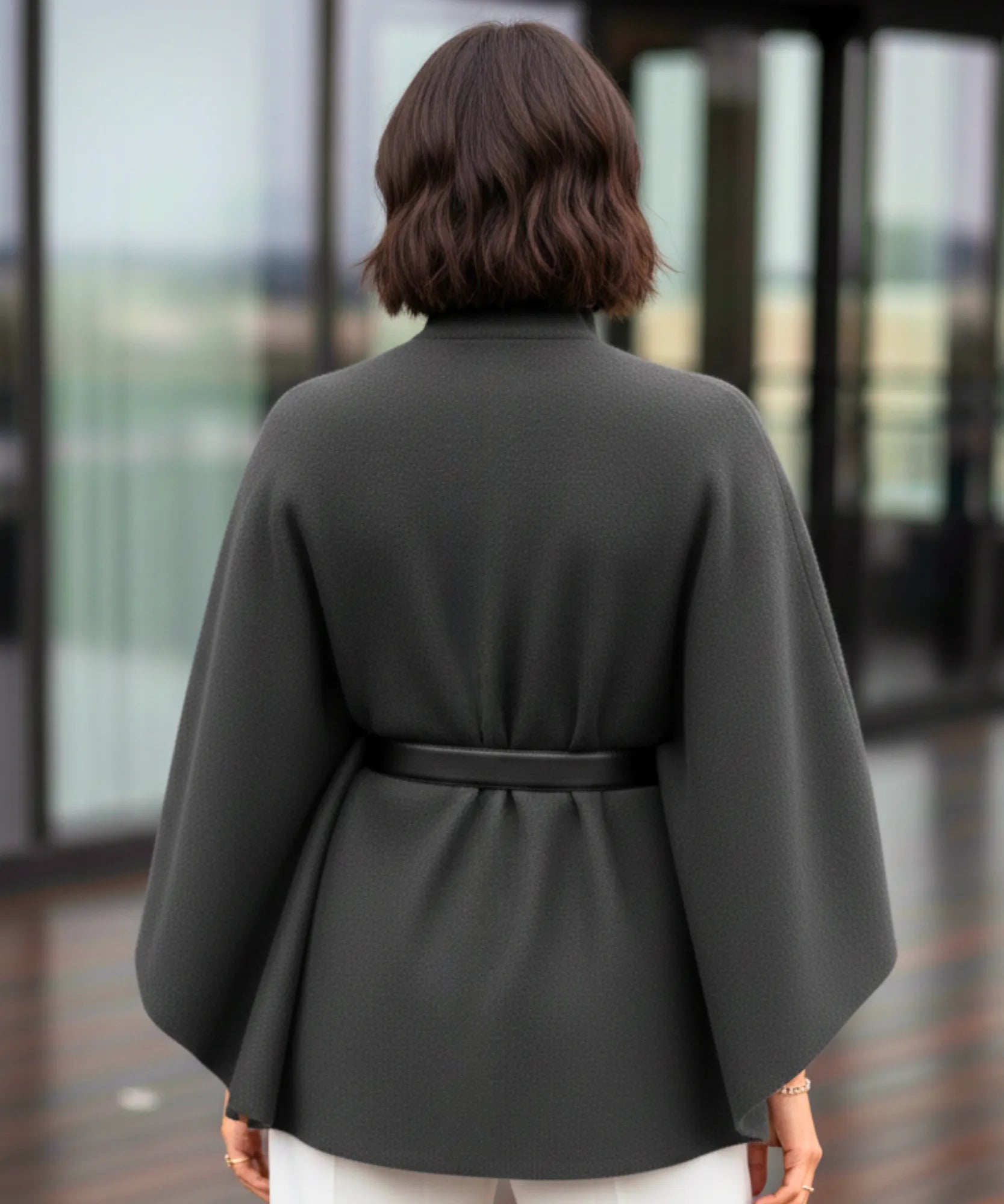 Women's charcoal grey mock-neck sweater poncho, styled look