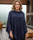 Women's hooded poncho sweater in navy chunky knit with fringe trim