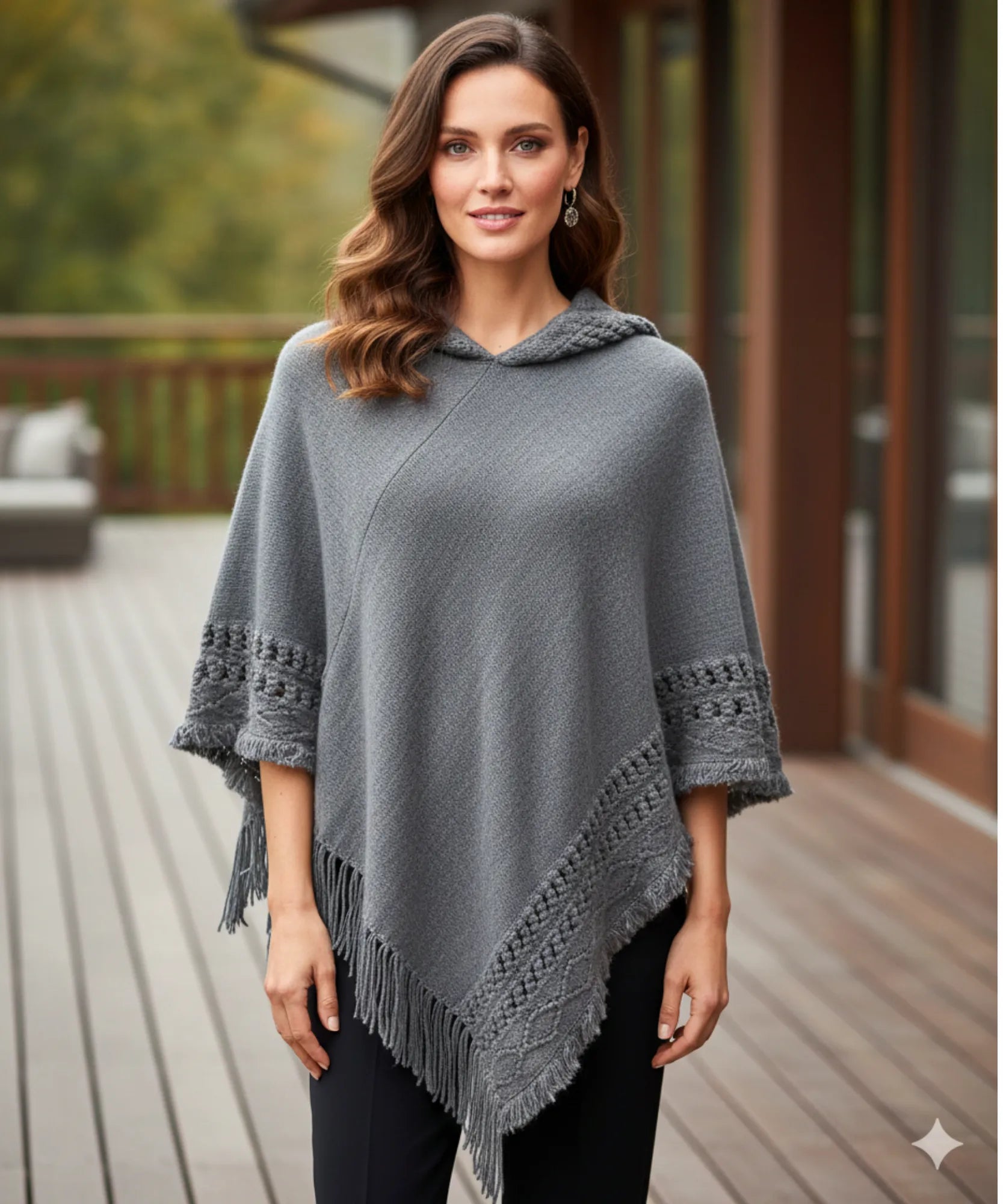 Women's hooded poncho sweater in grey chunky knit, fringe hem detail