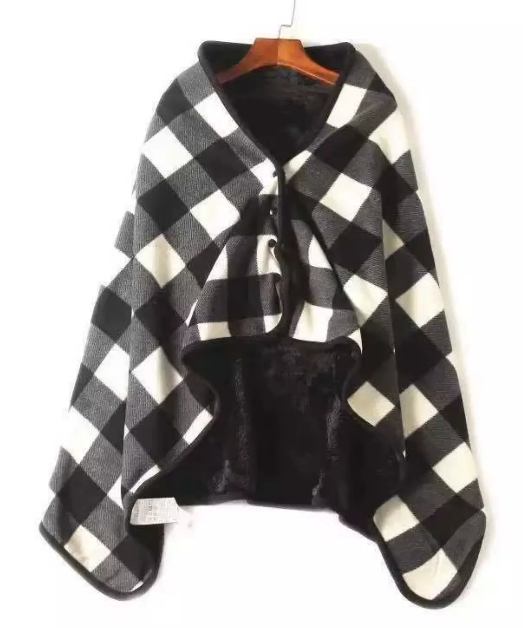 Women's plaid blanket poncho in black and white buffalo check, flat lay